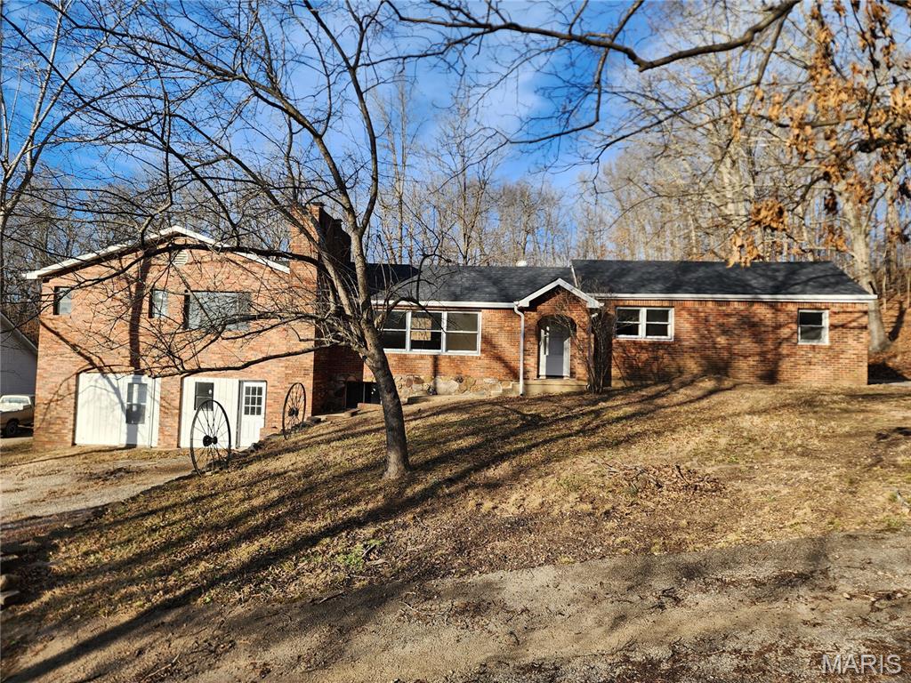 This large home is ready for a new chapter to be written.  The all brick exterior just received a new roof, a new deck and new outside AC condensing unit.  With over 3900 SF of living space this home offers many options.  It has been used as a rental property with four separate units available.  The home has 5 bedrooms, four baths and four kitchens in all but has four exterior entrances.  If you are looking for a large home for extended family, this would be perfect.  The owner has installed some new appliances, flooring and electrical updates recently as well.  All this sits on 1.35 +/- acres with a circle drive, basketball goal, brick fire pit and a concrete pad where a shop building used to sit.  Property is very near the St. Francis River and Wappapello Lake.  A person could live in the main area and rent out the two downstairs units.  Possibilities are endless.  Schedule your appointment for a personal viewing today.
