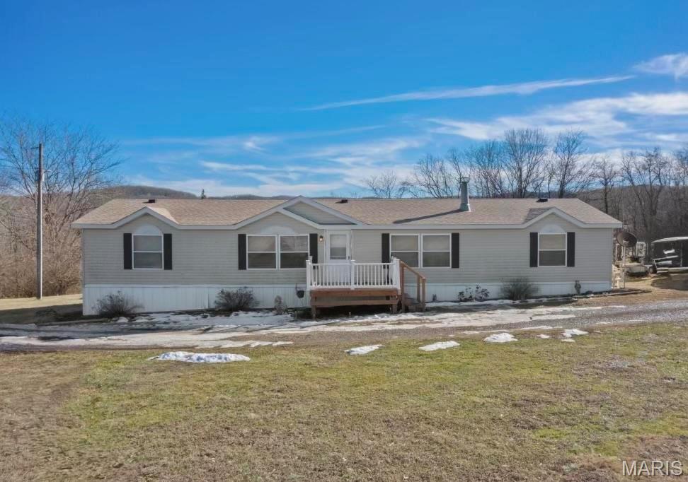 BACK ON MARKET!Charming country retreat on 10.65 acres in Elsberry, MO. Two tax parcels are being sold together. Lot 3 has lovely home that sits on 5 acres & Lot 2 is 5.65 acres (water & electric are on lot 2 as well) giving you grand total of 10.65 acres. Home offers over 1800+ sq.ft of comfortable living space. Through out you will find 3 bedrooms 2 bathrooms. Bedrooms have walk in closets, master bath has soaking tub with separate shower. Main floor laundry. Eat in kitchen with breakfast area. Separate dining that opens into living room along with great room for more seating with wood burning fire place. Enjoy the great outdoors from two decks outback that overlook a beautiful lake view, providing a gorgeous setting for relaxation and gatherings. With ample land surrounding the home there is plenty of room for outdoor activities, gardening, or even future expansions. Don’t miss out on this incredible opportunity. Schedule a showing & experience all this beautiful home and land have to offer!