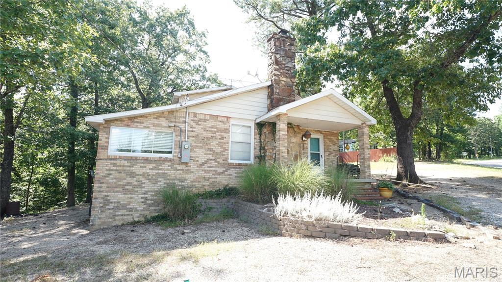 Charming 3-bedroom retreat overlooking Peoples Creek at Wappapello Lake. Located just seconds from the Peoples creek boat ramp, this 3-bedroom, 2-bath brick home offers the perfect blend of comfort and convenience in one of Wappapello lakes most desirable areas. Enjoy peaceful mornings and stunning views from the back deck overlooking People's creek--Ideal for nature lovers and lake enthusiast. The main level features a well-appointed kitchen with a pantry, spacious living areas, and two bedrooms. The private upstairs primary suite offers a quiet retreat, separated from the other bedrooms. A basement provides additional storage and safety during Southeast Missouri's unpredictable weather. Whether you're searching for a weekend lake house, a permanent home, or a turnkey Airbnb investment, this property checks all the boxes.