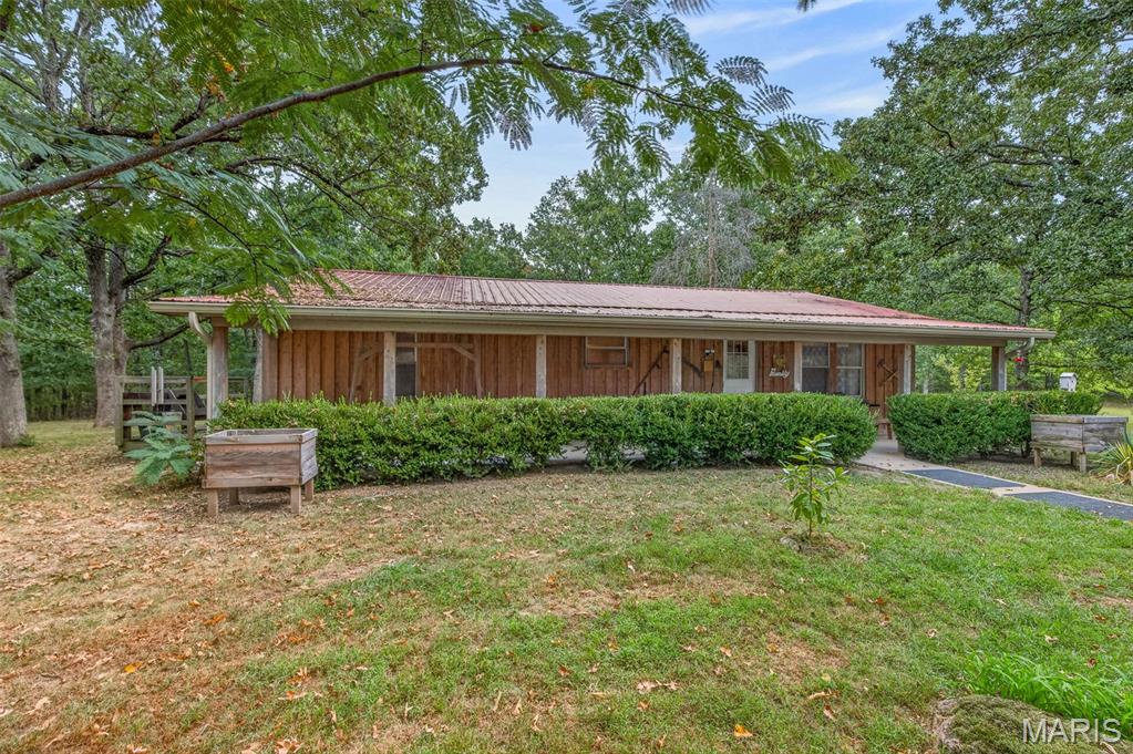 Feel your blood pressure lower as you drive down the lane.  So peaceful; beautiful trees and abundance of wildlife in your very own 24 acre tract.  Seller has a shooting range on the property for honing your rifle before deer season!  Fruit trees and grapes planted around the place. Oversized 2 car garage has enough room for a workshop.  Seller will leave all furnishings, 85" TV and appliances with the home.  Even the tractor is negotiable for a little extra money!  Seller has a transferable home warranty if you want to have it transferred at closing.