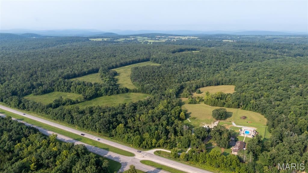 Rare opportunity to own 92 acres m/l with excellent Hwy 67 road frontage! This versatile property offers a desirable mix of wooded acreage and open pasture, providing plenty of options for recreation, livestock, hunting, or building your dream country property. Property has a barn and creek.