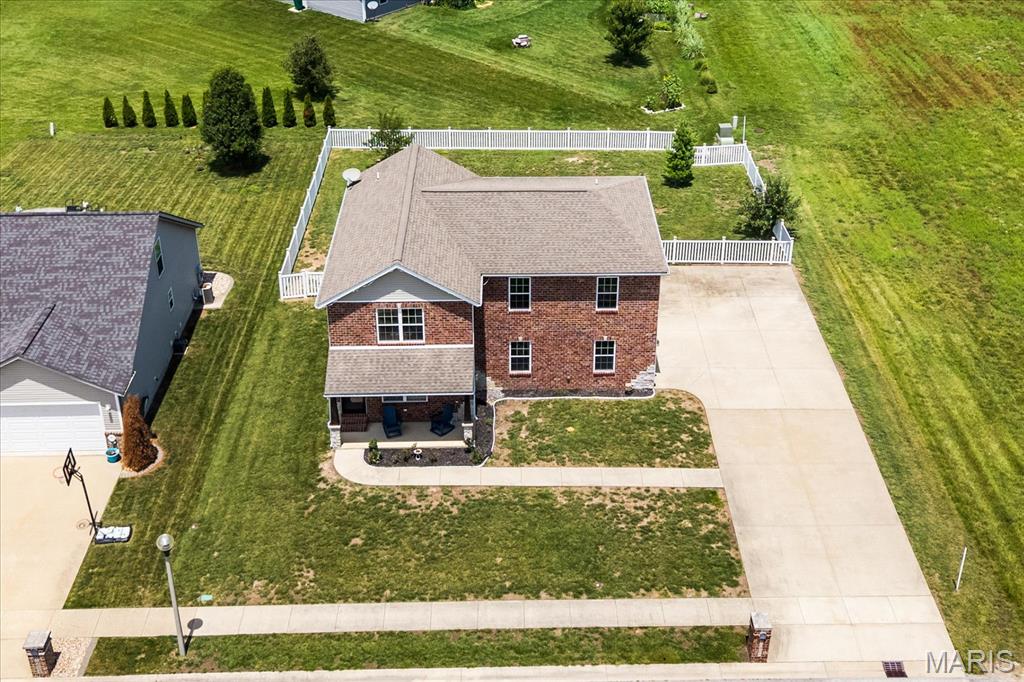 Welcome home to the space, style, and lifestyle you've been searching for! Built in 2015 and perfectly positioned at the end of a quiet street, this beautifully updated two-story offers modern living with room to grow, incredible outdoor space, and views of open ground and a peaceful pond—all with NO HOA!

From the moment you arrive, you'll appreciate the charming covered front porch, impressive curb appeal, and the oversized side-entry garage complemented by an expansive driveway with plenty of room for multiple vehicles, guests, trailers, recreational equipment, or your next weekend adventure.

Inside, the bright open-concept main level was designed for everyday living and effortless entertaining. Gather around the cozy fireplace in the spacious living room before flowing into the stunning custom kitchen featuring a large center island, pantry, modern cabinetry, abundant workspace, and views of the fenced backyard. Whether you're hosting friends for the big game, meal prepping for the week, or enjoying a quiet evening at home, this kitchen is truly the heart of the home. Step outside to an oversized patio complete with a fire pit—ready for summer BBQs, fall bonfires, and evenings under the stars.

Upstairs, you'll discover a spacious landing enhanced with custom millwork that creates the perfect flex space for a small reading nook, at home work station or displaying your memorabilia elegantly. The primary suite is exceptionally sized and feels like a true retreat, featuring an incredible walk-in closet and a beautifully appointed ensuite bath with a spa-inspired glass-enclosed shower. The additional fireplace mantal decor piece adds a touch of style and creates a cozy space for you! Two additional generously sized bedrooms provide excellent closet space large enough to accomodate a make-up vanity, a safe and more. That's not all, a well-designed color drentch full bath with spa like shower and storage is the icing on the cake!

The unfinished lower level offers endless possibilities with a convenient second secure garage entrance stair case with side door — ideal for future expansion, hobbies, storage, fitness space, or creating the custom lower level you've always envisioned.

The oversized attached garage isn't just for parking—it offers outstanding space for a maybe workshop, home gym, additional storage, or all the toys that come with an active lifestyle.

Located in the welcoming community of Breese, you'll enjoy the charm of small-town living with outstanding local parks, community events, restaurants, and schools while maintaining excellent access to everyday conveniences. Commuting is simple with quick access to major highways, approximately 35-40 minutes to Scott Air Force Base, and convenient drives to the Metro East and St. Louis region. Clinton County is known for its strong sense of community, beautiful countryside, and exceptional quality of life—making it one of Southern Illinois' most desirable places to call home.

If you've been waiting for a home that checks every box—modern construction, generous living space, oversized garage, incredible outdoor entertaining areas, privacy, scenic views, and no monthly HOA fees—this is the one you've been waiting for.

Welcome home to 10009 Patriot Drive. Your next chapter starts here. ***Please note virtual staging has been utilized in this listing. The home furnishings and decor items shown in marketing photos are not included in the sale.