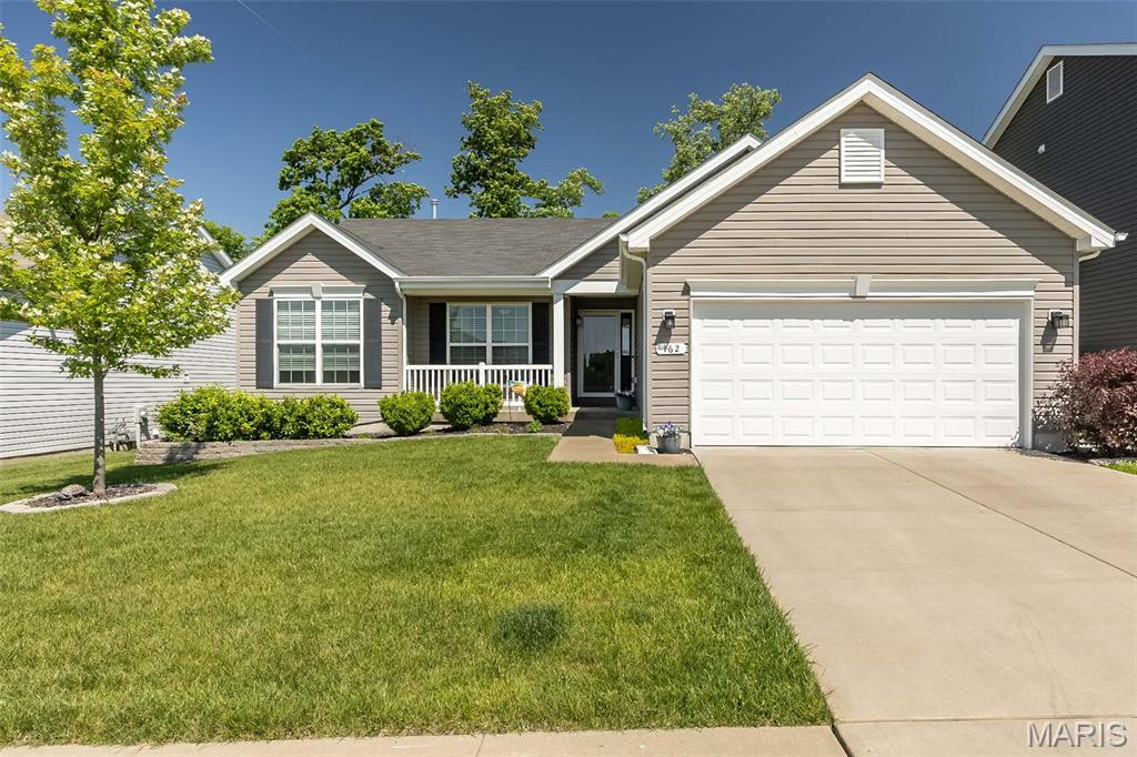 Experience the perfect blend of comfort, style, and convenience at **162 Hidden Bluffs Dr.**, nestled in the coveted Lake St. Louis area. This beautifully updated home welcomes you with fresh, neutral paint and an abundance of natural light, creating a bright and airy ambiance. Soaring vaulted ceilings and stunning laminate flooring elevate the open-concept living spaces, while plush new carpeting in the bedrooms offers cozy comfort.

The kitchen is a culinary haven, thoughtfully designed with stainless steel appliances, 42" cabinets, not one but *two* pantries, a dedicated coffee station, and a breakfast bar that’s perfect for casual mornings or hosting friends. The adjoining great room invites you to relax by the charming gas fireplace, making it the heart of the home.

Retreat to the luxurious primary suite, where you’ll find a coffered ceiling, an expansive walk-in closet, and a spa-like bathroom featuring a double vanity, a soaking tub, and a walk-in shower. Ceiling fans in each bedroom ensure year-round comfort, and the main floor laundry room adds a touch of everyday convenience.

Step outside through the dining area’s sliding glass doors to discover a large concrete patio, ideal for entertaining or simply soaking up the sunshine. The level, fenced backyard is beautifully maintained with an inground sprinkler system, offering a private oasis for outdoor fun. 

Looking for even more potential? The lower level is ready for your personal touch, complete with a rough-in bath, an egress window, and carbon fiber reinforcements for added peace of mind.

This home truly has it all—don’t miss your chance to call **162 Hidden Bluffs Dr.** your own!