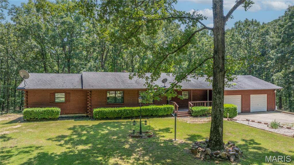 Tucked away on 15 beautiful acres just minutes from Lake Wappapello, this custom log home offers the perfect blend of privacy, space, and opportunity. Whether you’re looking for a full-time residence, weekend getaway, or potential short-term rental, this property delivers the lifestyle buyers are searching for. Surrounded by nature, the home features over 3,400 sq ft with 4 bedrooms and 3 bathrooms, giving you plenty of room to host family and friends. The warm wood interior, open living spaces, and peaceful setting create that true “cabin retreat” feel. Outside, the possibilities really open up, ample acreage for recreation, hunting, or simply enjoying the quiet. The shop building and RV storage add even more flexibility for outdoor enthusiasts or those needing extra space for equipment and toys. Properties like this don’t come along often in this area—especially with this much land and usability so close to the lake. If you’ve been looking for a private escape with room to breathe, this is one you’ll want to experience in person. Seller says bring offers!