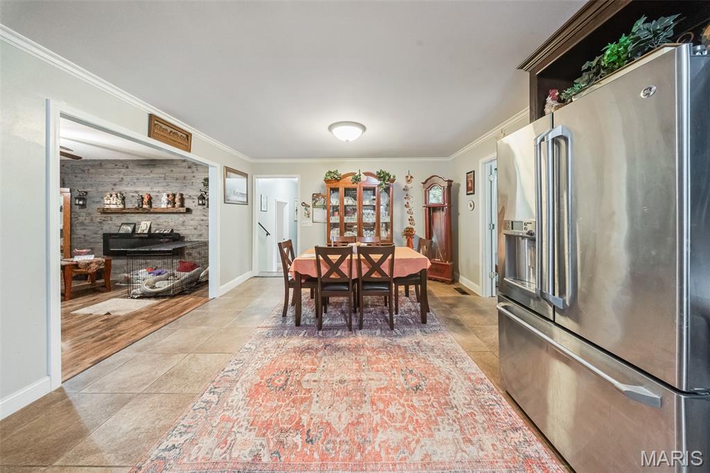 Welcome home to this charming 4-bedroom, 1.5-bath home in the heart of St. James! The inviting living room features a cozy electric fireplace and flows seamlessly into the dining area and beautifully appointed kitchen, complete with stainless steel appliances, tile backsplash, and custom cabinetry. Generous-sized bedrooms provide plenty of space for family, guests, or a home office, while the impressive laundry room adds everyday convenience. An attached one-car garage offers additional storage and functionality. Step outside to the back deck overlooking the fenced backyard, where mature shade trees create the perfect setting for relaxing, entertaining, or enjoying the outdoors. This move-in ready home combines comfort, style, and practicality—schedule your private showing today. This is a must-see!