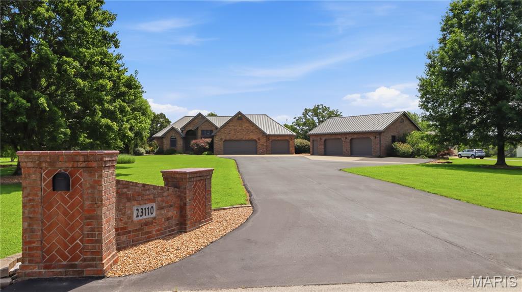 Are you looking for the kind of home that gives you space to breathe, room to gather, and convenience without giving up privacy? This beautifully maintained 4-bedroom, 3-bath home sits on just under 2 flat acres on a quiet dead-end street outside city limits, yet still keeps you minutes from shopping, restaurants, healthcare, and interstate access.

Step inside to a wide-open foyer that leads into a spacious living room filled with natural light from tall windows and anchored by a cozy gas fireplace. The tall ceilings continue into the inviting kitchen, where solid-surface countertops, an undermount sink, plentiful cabinetry, and a warm, attractive design create a space that feels both functional and welcoming. Enjoy meals in the bright eat-in kitchen surrounded by windows, or use the formal dining room as intended, as an office, or as the flex space that fits your life.

The main level offers a split-bedroom floor plan with two generously sized guest bedrooms, a full guest bath, and a spacious primary suite with room for a king bed, dressers, and a quiet sitting or reading area. The recently updated primary bath feels like a retreat, featuring a beautiful walk-in shower, double vanity, and large walk-in closet.

Downstairs, the finished basement opens up even more possibilities with a bar, full bathroom, non-conforming bedroom, extra flex/storage space (could also be used as a non-conforming bedroom), and a massive common area ready for a pool table, home theater, craft space, game room, or whatever your lifestyle needs.

And then there are the garages. The attached 3.5-car garage offers incredible everyday storage and convenience, while the detached 2.5-car garage is a dream setup for car lovers, hobbyists, collectors, or anyone needing serious shop space. Built with an extra-high ceiling to accommodate a lift, it is ready for vehicles, tools, toys, projects, or the ultimate hangout space.

Outside, the 1.97 flat acres give you room to entertain, grill on the oversized stamped concrete patio, enjoy yard games, garden, add a pool, or simply relax with room around you. With space, flexibility, privacy, and convenience all in one package, this is the kind of property that is hard to find and easy to love. And then throw in the energy efficiency with year-round low electric bills as well as a hard wired whole house generator to keep you safe and cozy when you need it most! Schedule your showing today.

More pictures coming soon