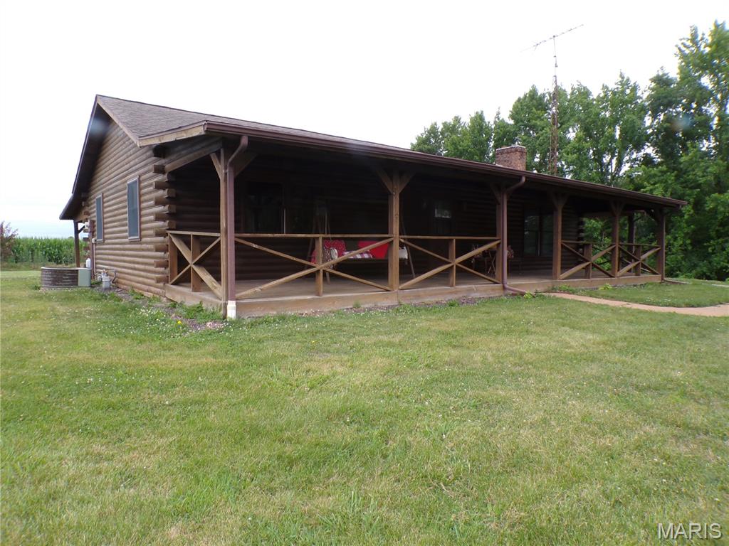 This adorable country log cabin may be your heart's desire. It is listed as a 2 Bedroom home but has TWO Bonus Rooms that easily could be used as spacious sleeping areas. This home located just south of Pinckneyville was originally built by the owner’s family but is ready for a new owner. Not one but two 12 X 40 covered porches spanning the entire length of the home are there for your enjoyment. The front porch is wood and has plenty of room sit and enjoy the great outdoors. Ubelievably the rear covered 12X40 ft. porch is concrete, located on the east side of the home so most of the day is a shaded outside getaway. This is a wonderful place to entertain out of the public eye. Included is a 30 X 40 metal shed able to be used as a workshop or great storage for you ongoing projects! Doesn't everyone need one? This 2.11 acre home is a haven created just for you and your family. Make an appointment to see it today.