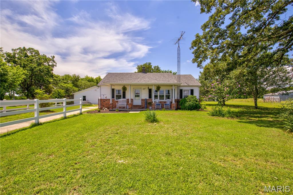 Escape to the peace and quiet of rural Scott County with this charming 3-bedroom, 1-bath home situated on approximately 1.5 acres just a half mile from Thomas W. Kelly School. Surrounded by scenic farmland, this property offers the perfect blend of country living and convenience.

Outdoor enthusiasts and hobby farmers will appreciate the barn complete with a chicken coop and attached small animal pen, along with ample space for gardening and animals. The property features more than 10 varieties of flowering plants and a mature pear tree that produces fruit seasonally. A storm cellar provides added peace of mind during severe weather and offers additional storage space that can be used for canning and preserving homegrown goods.

Recent updates include a new dishwasher, new attic insulation, a new septic system, and a well pump that is only 3 years old. Previous owners also installed a new roof and replacement windows within the last 6-10 years. Whether you're looking for a peaceful retreat, room to roam, or a place to start your hobby farm, this property is ready to welcome you home.