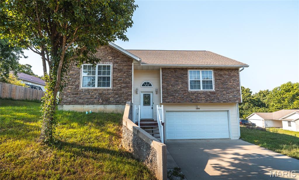 Discover the perfect combination of space, comfort, and convenience in this beautifully maintained 4-bedroom, 3-bath home in St. Robert, MO. Nestled in a quiet subdivision just minutes from Fort Leonard Wood's main gate, this home also offers quick access to shopping, restaurants, schools, and everyday amenities, making it an ideal choice for military families, commuters, or anyone seeking a move-in-ready home in a prime location. Step inside to an inviting open floor plan enhanced by soaring vaulted ceilings that create a bright, spacious atmosphere. The heart of the home is the oversized kitchen, thoughtfully designed with stainless steel appliances, abundant cabinetry, and a large breakfast bar that naturally becomes the gathering place for family meals, casual conversations, and entertaining guests. The seamless flow between the kitchen, dining, and living areas makes everyday living effortless. The spacious primary suite offers a peaceful retreat with an elegant tray ceiling and a luxurious ensuite bath featuring a dual vanity, a relaxing Jacuzzi tub, and a separate walk-in shower. Three additional bedrooms and two more full bathrooms provide plenty of flexibility for family, guests, or a home office. Outside, you'll enjoy the peaceful surroundings of this desirable neighborhood while remaining just minutes from everything St. Robert has to offer. Whether you're looking for extra space, modern comfort, or a convenient location near Fort Leonard Wood, this home checks every box. Don't miss your opportunity to own this exceptional St. Robert home. Schedule your private showing today and experience everything this beautiful property has to offer!