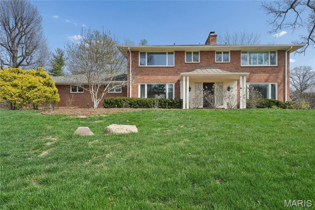 Four-bedroom, two-story colonial charmer in Ladue located in the heart of the sought-after Briarcliff neighborhood and within Ladue Schools (Reed Elementary). Offering approximately 4,430 square feet of living space on three levels, this home sits on a beautiful level 0.73-acre wooded lot with room to add a swimming pool. The updated center-island quartz kitchen features a Wolf gas cooktop and oven, Sub-Zero refrigerator, wine/beverage refrigerator, and a walk-in custom pantry. Refinished white oak floors run throughout the main level and upstairs bedrooms. The main floor includes a charming four-season sunroom with wood flooring and a wonderful private home office. The second floor offers four bedrooms and three full baths. The spacious finished lower level includes a 30’ x 25’ rec room, 22’ x 15’ playroom/art room with ceramic tile, sink, refrigerator, and dog shower, plus an additional full bath with shower. Additional amenities include a second-floor porch area, upstairs laundry, brick patio, two fireplaces, two-zone HVAC, two water heaters, and an architectural-style roof. Highlights also include a 16’ x 13’ mudroom and an impressive 14’ x 5’ walk-in primary closet with custom built-ins. Conveniently located near highways, the airport, shopping, restaurants, and several private schools.