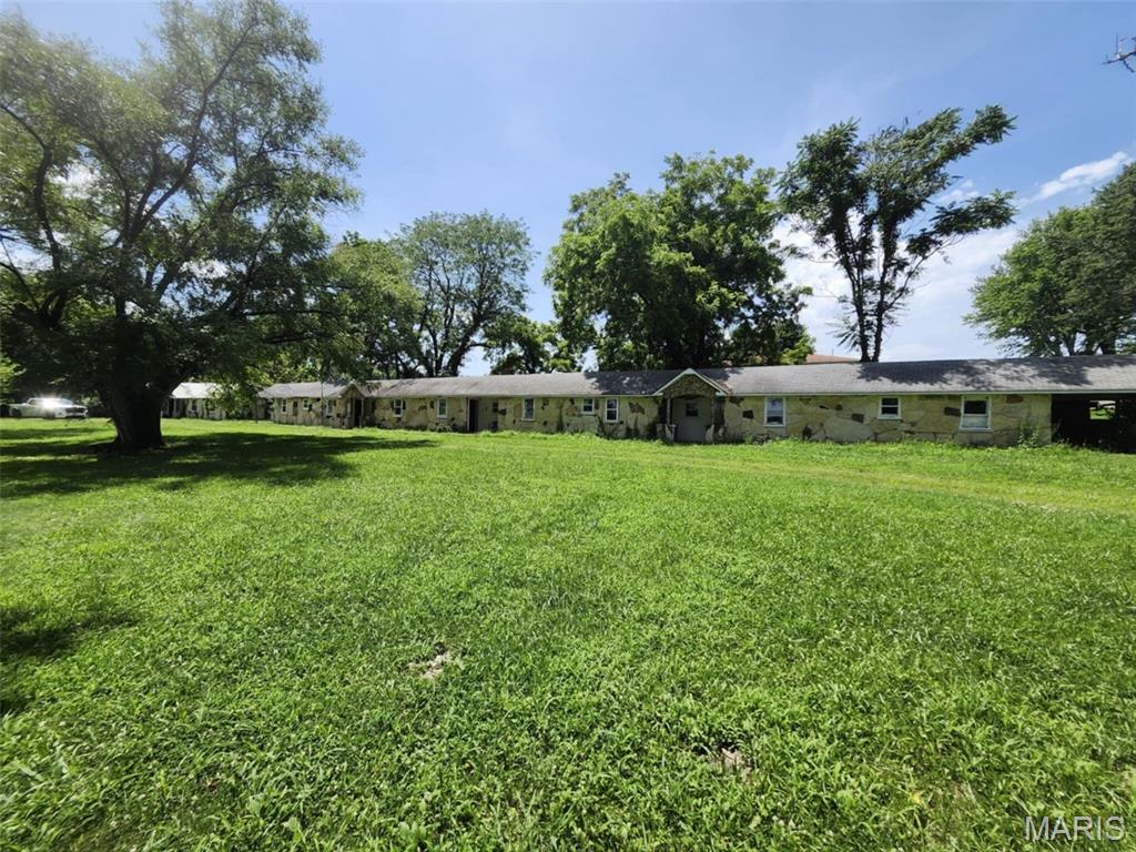 Nostalgic Multi-Unit Motel or Apartment Investment Opportunity - Cabool, Missouri. Located at the north entrance of Cabool in the scenic Southern Missouri Ozarks, this vintage native stone motel, built in 1940, offers a unique opportunity for restoration and repurposing. While the property shows its age, it's full of potential--whether transformed into long-term housing, overnight rentals, or a combination of both. The property also includes an Artesian well housed in a historic stone well house behind the main building--an added touch of character and charm. Relax beneath the mature shade trees out front, enjoying the peaceful, small-town atmosphere as you watch the cars pass by. This property is ready for new life and vision--don't miss the chance to bring it back to its full glory.