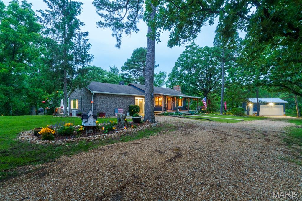 Looking for that cozy home in the country just minutes from town? Here it is! Located on a 2+ acre well-manicured lawn with beautiful trees, this 3 bed/2 bath home has a lovely covered front porch and TWO spacious decks. These provide great entertainment space or just a relaxing place to view the natural beauty that surrounds this home. The circular driveway makes for easy-on/easy-off access to a state maintained highway. On the inside, this home has been updated with care. The newly remodeled kitchen has a custom bamboo sink, stainless steel appliances, beautiful cabinets and a bar-top breakfast table with stools. The dining room/hearth room is located just off the kitchen and offers a wood-burning fireplace with an insert for those chilly evenings. The spacious family room is perfect for relaxing and entertaining. Or take advantage of the room darkening shades to make it a fantastic media room! There is a new detached garage complete with side door and automatic door opener. Call today for your private showing!