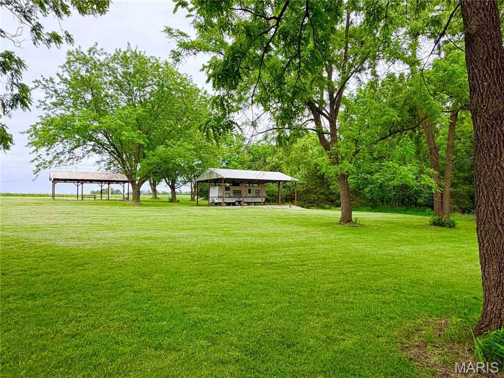 Discover the perfect blend of recreation and opportunity with this 4.92+/- acre property located just minutes from Mark Twain Lake. Whether you're looking for a weekend retreat, a future homesite, or a flexible investment, this property is ready to go.
Equipped with two covered camper hook-ups—both featuring electric, water, and a holding tank—this setup makes it easy to start enjoying the property immediately. One covered space includes a full concrete floor, adding durability and convenience for long-term use or additional outdoor living space.

Ideally situated just 10 minutes from Clarence Cannon Dam, Blackjack Marina, and Ray Behrens Boat Ramp, you’ll have quick access to some of the best boating, fishing, and outdoor recreation the area has to offer.

With nearly 5 acres to work with, the possibilities are truly endless—build your dream lake home, create a private getaway, or continue using it as a fully functional camper retreat. Located within the Ralls County School District, this property also offers long-term residential appeal. Survey to be completed.

Don’t miss this versatile property near the lake—opportunities like this don’t come around often!