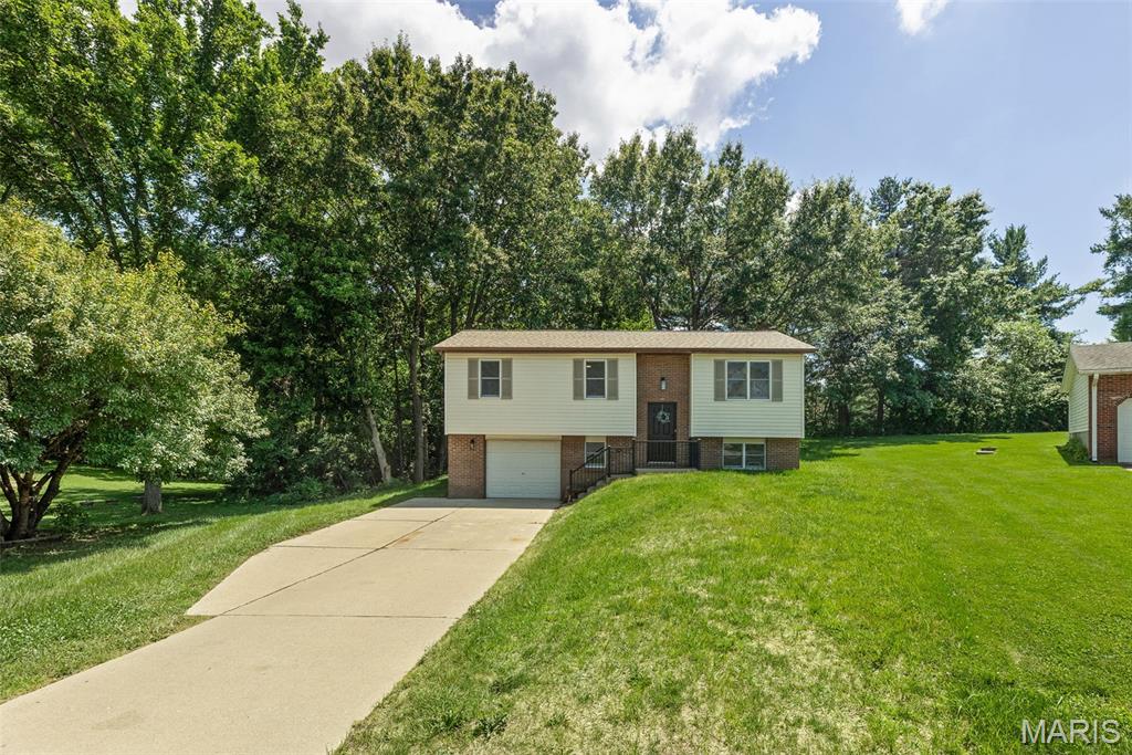 Beautifully updated and move-in ready! This 3 bedroom, 2 bathroom home offers modern finishes, thoughtful updates, and a functional layout in a desirable Godfrey location. The main level features a spacious living room, updated kitchen with white shaker cabinetry, stainless appliances, and dining area with access to the brand-new deck overlooking a private wooded backyard. Updated flooring, fresh paint, and renovated bathrooms create a clean, modern feel throughout. The finished lower level adds valuable living space with a family room, third bedroom, and dedicated laundry room with epoxy flooring. Major improvements include a new roof, updated HVAC system, new water heater, new deck, and numerous interior updates. Attached one-car garage. Enjoy the benefits of a move-in ready home with both cosmetic and mechanical updates already completed. Conveniently located near shopping, dining, parks, and everyday amenities.