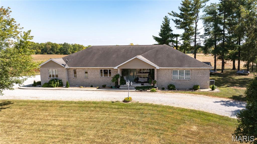 Open House Sunday September 21, 2025 from 1pm-3pm.  Custom-built, one-owner home on 3 acres! This 3BR/4BA home features 3 bonus rooms, spacious living room, open kitchen/dining combo with huge center island & breakfast bar, walk-in pantry, and sunroom with wet bar. Main-floor primary suite includes secondary laundry in walk-in closet + main-floor laundry closet for convenience. Mostly finished lower level offers extra living space and additional kitchen. Enjoy the covered front porch, concrete patio, attached 2-car garage, plus a detached 2-car garage. Meticulously maintained—schedule a showing today!