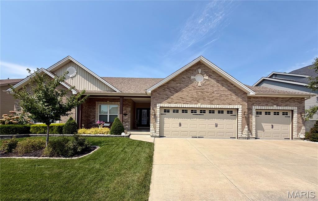 Prepare to be impressed by this stunning 4-bedroom, 2 full, 2 half bath home offering over 3,600 square feet of finished living space, including a finished basement. Designed for both everyday living and entertaining, this home features a huge open floor plan with beautiful wood flooring, a spacious kitchen, separate dining room, and inviting hearth room that creates the perfect gathering space.   The main living space is expansive with 9' ceilings, gas fireplace in living room and views of the back yard from multiple rooms.  Beautiful Kitchen with island stainless appliances, breakfast bar, and walk in pantry.  Hearth room off the kitchen provides great extra space with door to the back yard.  The impressive primary suite features double-door entry and a luxurious en suite bath complete with two vanities, a separate shower, soaking tub, and private water closet.  Bedrooms 2 and 3 are standard secondary bedrooms while bedroom 4 is currently used as an office with wood floors and French doors entry.  Generous sized main floor laundry and a powder room off the kitchen round out the main level.  The finished basement (with egress window)  provides additional flexible living space for a recreation room, home office, gym, media area, or whatever your lifestyle requires.   Step outside and discover one of the home's standout features—a massive covered patio overlooking a flat, spacious, tree-lined backyard. Don't forget the remote powered 50inch TV that drops out of the ceiling of the covered patio!  It's an ideal setting for outdoor entertaining, relaxing, or enjoying your morning coffee.  The spacious backyard is level and somewhat private and the the entire lawn is kept looking perfect by the homes irrigation system.  The oversized three-car garage is another major highlight, offering both extra depth and extra width, providing plenty of room for vehicles, storage, hobbies, or recreational equipment.  Fort Zumwalt West Schools.  Close to all the shopping and restaurants you could want.  Easy access to HWY's 364, 40 and 70.  Don't miss the opportunity to make this exceptional home yours!