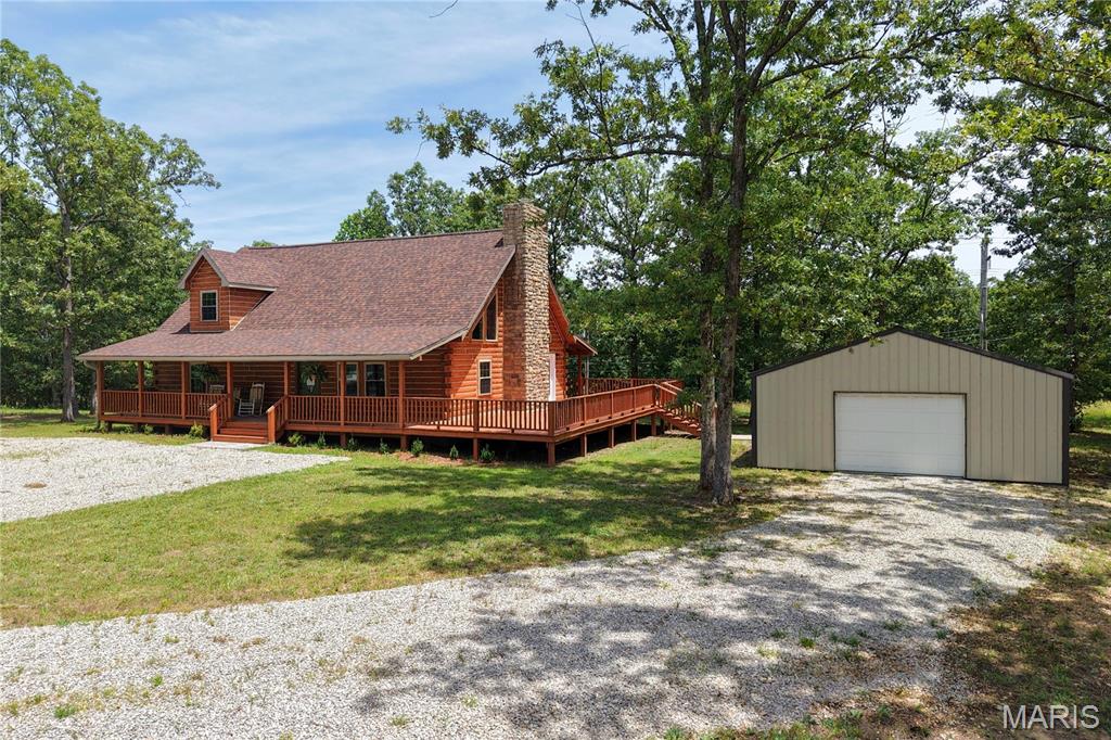 If you've been dreaming of a stunning log cabin with modern updates and room to roam, this is the one! Situated on just shy of 20 acres, this beautifully renovated 3-bedroom, 2-bath home has been thoughtfully updated from top to bottom while preserving its rustic character.
Step inside to find soaring vaulted ceilings with exposed beams, gorgeous genuine wood flooring, an impressive stone wood-burning fireplace, and an open-concept floor plan perfect for entertaining. The kitchen is a showstopper with granite countertops, stainless steel appliances, soft-close cabinetry, and quality finishes throughout. The main level features two spacious bedrooms and a fully remodeled bathroom, while the upstairs primary suite offers abundant closet space and a luxurious ensuite complete with a clawfoot soaking tub, walk-in shower, and double vanity. A screened-in walkout porch off the upper level and wraparound decking on three sides—covered on both the front and back—provide incredible spaces to relax and enjoy the surrounding views.
The updates are truly extensive, including a new roof, chimney, windows, PEX plumbing throughout, electrical, insulation, sheetrock, paint, fixtures, cabinets, water heater, appliances, genuine wood flooring, and tile—all completed in 2026. The heating and cooling system was replaced in 2022, offering additional peace of mind.
Outside, you'll also find a newer 30x24 shop with concrete floors and electric, making it ideal for storage, projects, or business use. With nearly 20 acres of privacy and a home that has been meticulously renovated, this is a rare opportunity you won't want to miss. Schedule your private showing today!