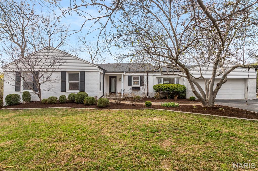 Charming, thoughtfully updated white-brick ranch in the award-winning Ladue School district (Reed Elementary). This classic 1950s home is move-in ready and offers a highly functional, easy-flowing floor plan designed for everyday living and entertaining. The recent kitchen remodel added new cabinetry and quartz countertops and opened sightlines to the dining area, while an adjacent den tucks off the kitchen and walks out to a 2024 Trex deck—ideal for morning coffee or summer gatherings. The living and dining rooms are generous and filled with natural light; the living room centers on a wood-burning fireplace, creating a warm, welcoming gathering space. The main level includes three bedrooms and two full baths, highlighted by a primary suite with its own en suite bath for privacy and convenience. The finished lower level adds roughly 1,000 sq ft of versatile space: a large rec room, a third full bath (new shower 2025), and a substantial flex room perfect for guests, a home office, or a gym. Laundry and ample storage are also on the lower level, with easy walk-out access to the yard. Set on nearly half an acre of mostly flat lawn for outdoor living and play, the property also includes an attached two-car garage. Recent upgrades:  HVAC (2021) with newer ductwork and whole-house humidifier, custom organized closets by STL Closet Co, new blinds throughout the main level (2026), Hunter Douglas custom blinds in den, and fresh professional paint (2026). This well-situated, lovingly updated home offers practical layout and timeless appeal.