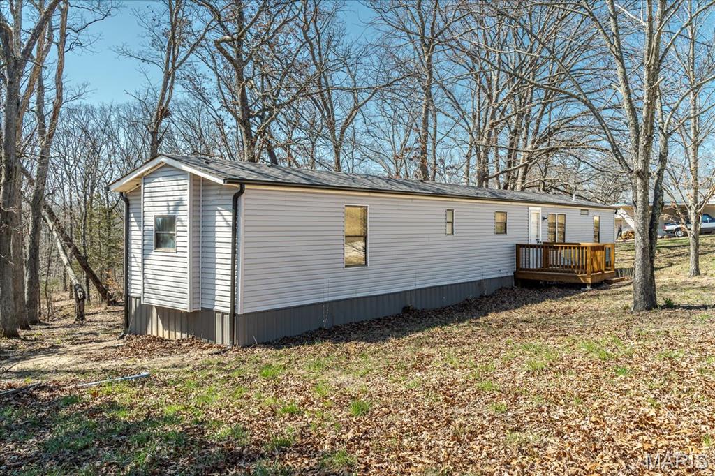 Completely remodeled two bedroom two bath home backing up to woods. Nearly two acre lot in the county. Just about everything is NEW... HVAC, appliances, windows, electric, hot water tank, paint, flooring, plumbing and bathrooms, siding, under pinning, front and back deck, and roof is only 5 yrs old. Must see to appreciate.