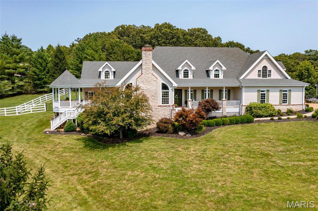 Gated entrance leads to a tree lined driveway up to an EXQUISITE cust. built 1.5 story home resting gracefully on 5.4+/- acres providing peace & tranquility w/ a 1+/- acre stocked pond & a completely fenced property. The home boasts 4 Bedrooms, 3 full & 2 half baths, 4,125+/-sqft, separate entrance for in-law suite w/kitchenette, pro dog kennel/dog run & an unfinished walkout basement w/great potential for additional living space. Covered front porch greets you as you step inside. Living room features a floor-to-ceiling stone/brick FP, 17’ vaulted ceiling w/wood beams, & walkout to side porch. Eatin kitchen w/cust. cabs, SS applis, center isl, stone backsplash, floor-to-ceiling stone/brick FP & walkout to covered patio. Owner’s suite w/wood flooring, tray ceiling, walkout to side porch, walkin closet & bath boasting double vanity, shower & jet tub. Dining, 2 mud rooms, dog kennel room & laundry complete the main level. Upper extends living w/ a loft, 3 addit'l bedrooms & in-law suite. Additional Rooms: Mud Room