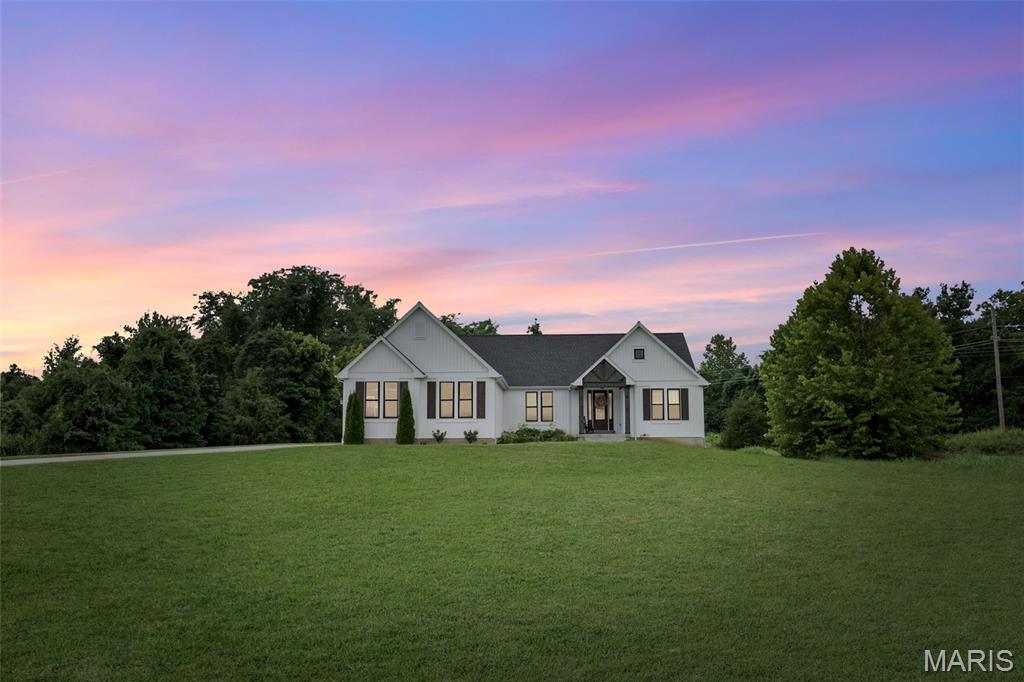 Welcome to luxury living in one of the most desirable locations within the highly sought-after Festus School District! Nestled on over 2 private acres at the end of a quiet cul-de-sac, this stunning custom-built, 6-year-old home offers the perfect blend of timeless elegance, modern design, and energy-efficient living. Move-in ready and meticulously maintained, this property is one you'll be proud to call home.

From the moment you arrive, you'll be captivated by the home's stunning modern farmhouse curb appeal, featuring a beautiful white board-and-batten exterior accented with rich wood details, black windows, and a welcoming covered front porch. Situated on a beautiful 2+ acre lot, complete with a lawn irrigation system, this property offers the perfect balance of privacy, beauty, and functionality.

Inside, you'll discover an impressive open-concept floor plan featuring over 2300 square feet with 6 bedrooms, 4 full bathrooms, and a spacious 3-car garage. Soaring ceilings, elegant 8-foot interior doors, rich lvp flooring, and a dramatic vaulted living room create a bright, airy atmosphere that feels both luxurious and inviting.

At the heart of the home is the beautifully designed chef's kitchen, showcasing custom cabinetry, sleek quartz countertops, a large center island with seating, and premium Café appliances that all stay. Whether you're hosting family gatherings or enjoying a quiet evening at home, the kitchen flows seamlessly into the dining area and spacious living room, making entertaining effortless!

The primary suite offers a peaceful retreat with a tray ceiling and a spa-inspired ensuite featuring a separate soaking tub, walk-in shower, double vanity, and an oversized walk-through closet. Every bedroom features its own walk-in closet, providing exceptional storage and convenience throughout the home. Main-level laundry adds even more everyday functionality.

The partially finished lower level expands your living space with a large recreation room, kitchenette, additional bedrooms and bathroom, and endless possibilities for entertaining, hosting overnight guests, or creating an in-law suite. 

Step outside to enjoy more than 2 acres of privacy offering plenty of room to relax, play, or create your dream outdoor retreat!

Custom built with exceptional craftsmanship, thoughtfully designed for everyday living, and loaded with premium features, this energy-efficient home truly checks every box. Luxury, comfort, space, and style come together in one remarkable property. Homes of this rarely become available—schedule your private showing today!
*Ask me how to get a $2,500 closing cost credit when you purchase this home!*