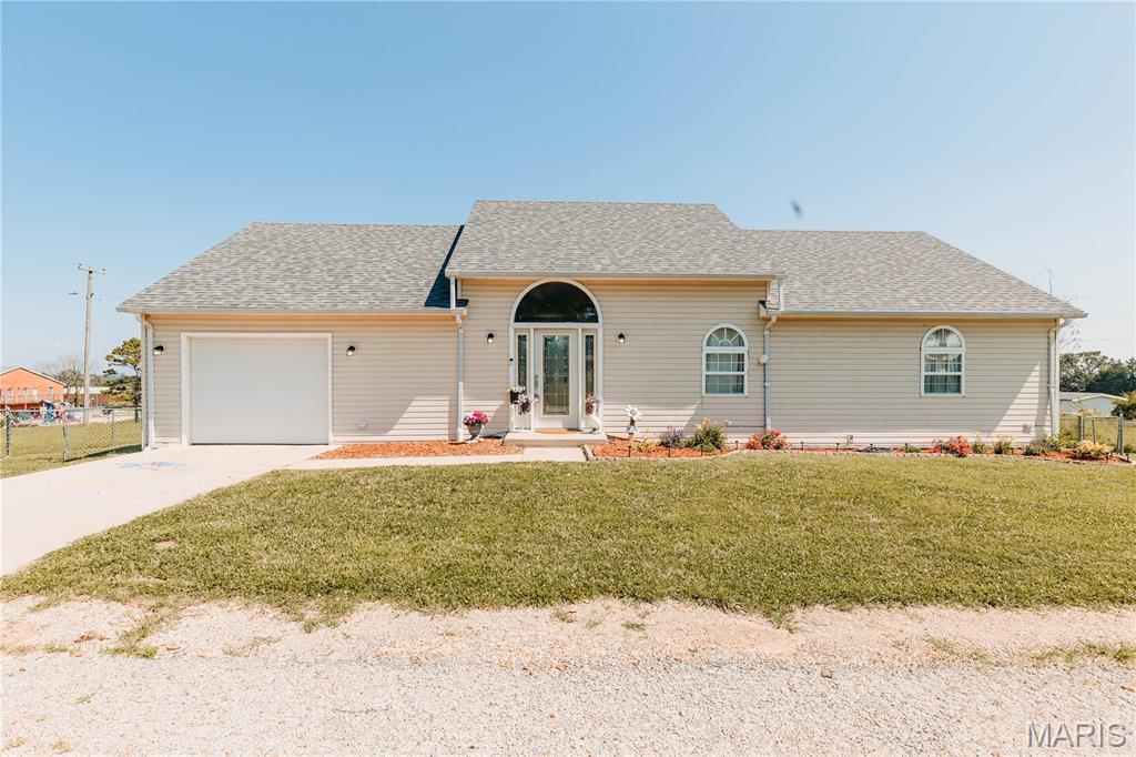 Combining an open-concept design, functional layout, and inviting outdoor spaces, this move-in-ready home offers the perfect balance of comfort, entertaining, and everyday living. Welcome home to this 3-bedroom, 2-bath ranch nestled on a spacious corner lot with room to enjoy both indoor comfort and outdoor living. Step through the impressive front entry where soaring ceilings, arched door ways and windows, millwork, and abundant natural light create a warm, inviting first impression. The thoughtfully designed open floor plan brings the great room, dining area, and kitchen together. The kitchen is designed with everyone in mind, offering generous cabinet, open shelving, color, and countertop space, updated finishes, and a layout that keeps everyone connected. Just off the dining area, the newly updated deck provides the perfect extension of your living space. Privately located at the back of the home, the spacious primary suite features a walk-in closet and private bath, offering a peaceful retreat. Two additional bedrooms and a full guest bath provide flexibility for family, guests, or a home office. Outside, relax on the expansive deck while taking in views of the open field beyond the backyard. The large fenced yard offers plenty of space for recreation, pets, gardening, or outdoor activities, while the established chicken coop is ready for those who appreciate a touch of country living. Additional features include an oversized attached garage with ample storage, landscaping, and the convenience of a corner lot.