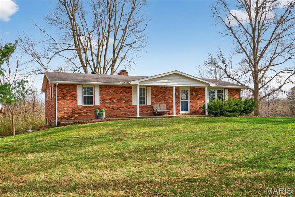 A great start to your gardening!  on over 1 1/2 acres. This updated brick ranch features peaceful living inside and out! Numerous fruit, flowering plants and mature trees.  Feel like country but close to town.  Plus a 20x26 insulated workshop with electric . The chicken coop is top notch; it can stay along with the chickens! A truly fresh morning breakfast! Inside ease of living with NO CARPET! including hardwood floors and LVP. Updated with a new HVAC and oversized water heater!  and when you're ready to relax, each room in the 3 bedroom/ 3 bath home is spacious and nicely updated. Dont miss all the bonus are in the walk out basement.