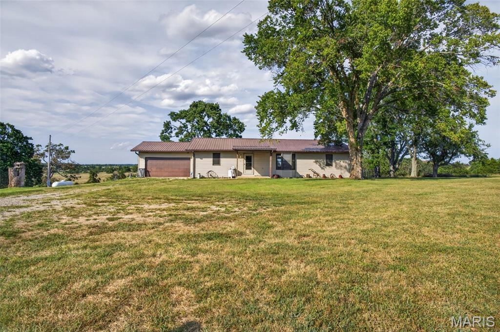 Enjoy the space and privacy of country living with this 3-bedroom, 2-bath home situated on 3.6 acres near Cabool, Missouri. Offering approximately 1,456 square feet, the home features a functional single-level layout with a roomy kitchen, generous cabinet storage, and comfortable living and dining areas. French doors open to a large back deck, creating an easy transition to outdoor living with plenty of room for grilling, relaxing, or entertaining. The property also offers open, usable yard space, mature shade, and peaceful views of the surrounding farmland. An attached 2-car garage provides convenient parking and additional storage, while the owned propane tank is another practical bonus. Located in the Cabool School District, this property offers plenty of room to spread out while remaining convenient to town. Come see all this property has to offer!