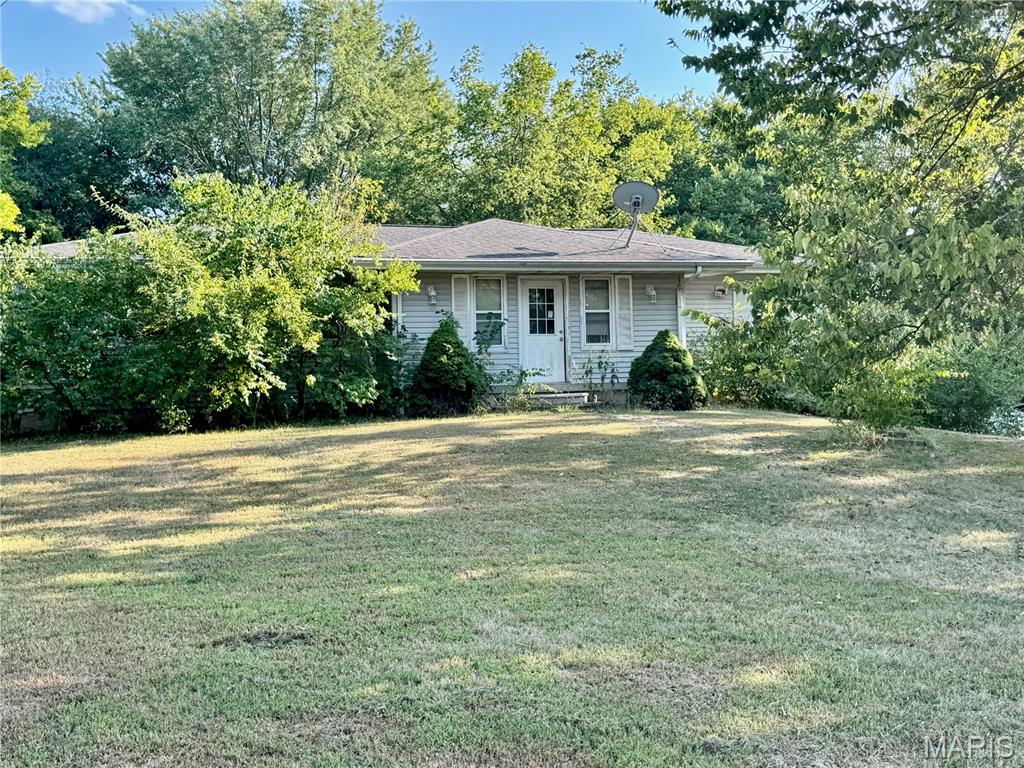 Looking for acreage, privacy, and potential? This 3-bedroom, 2-bath home sits on approximately 5 acres, offering a peaceful setting tucked back off the road while still being conveniently close to town. The property features a nice mix of open yard and timber to the rear, providing privacy, shade, and plenty of room to enjoy the outdoors.

Inside, the home offers a functional layout and a great opportunity for someone ready to bring their own ideas and improvements. The property does need updating, repairs, and some TLC, but has plenty of potential to become a wonderful country home. Whether you're looking for a place to renovate and make your own or simply want acreage without being too far from everyday conveniences, this property is worth a look. Home is being sold AS-IS.

Bring your vision and see what this 5-acre property has to offer!