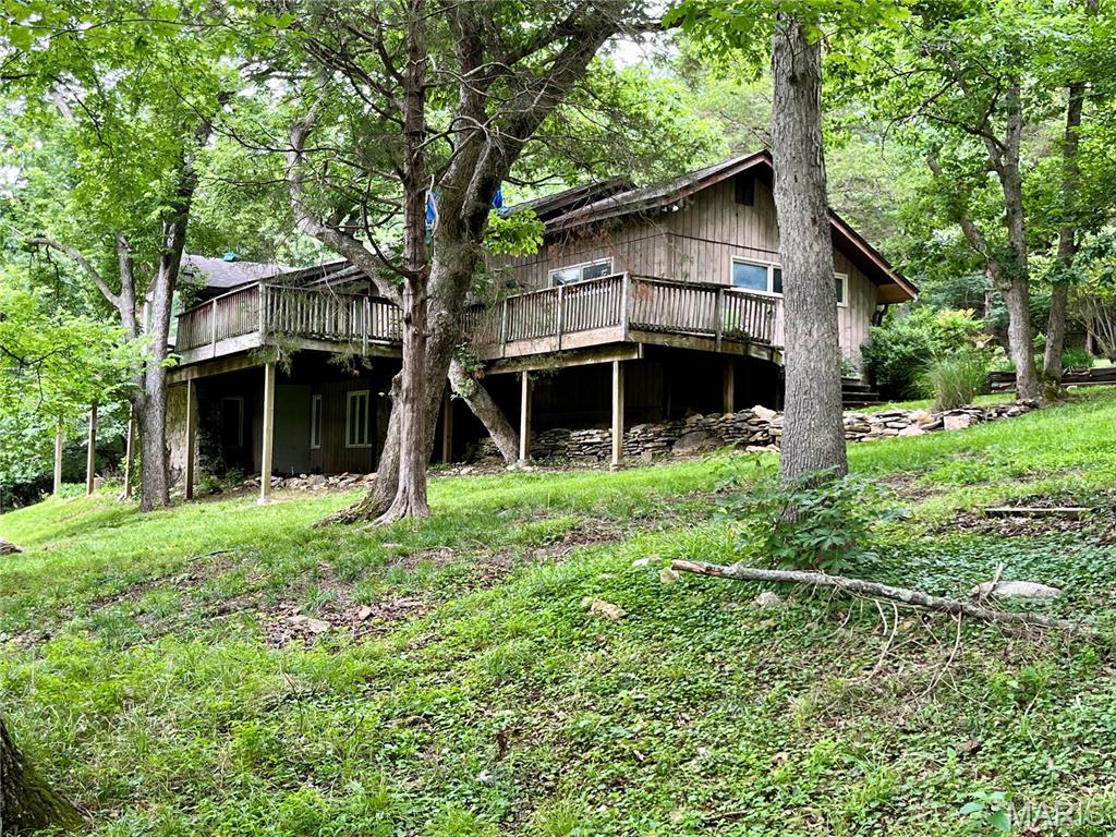 Opportunity awaits on 3 picturesque acres in sought-after Wildwood. This spacious home offers a blend of updates and potential, with improvements already completed in the kitchen and primary suite. Enjoy the peaceful setting, mature trees, and privacy that make this property truly special. Some portions of the home have been beautifully updated (kitchen with a 10 ft wrap around pantry with a sink and primary en suite with a stunning 4x5 ft walk in shower and separate soaking tub, a 10x6 walk in closet with an additional vanity space.) Other areas of the home will require repairs and improvements, offering the perfect opportunity for buyers to add their own vision and value. Whether you're looking for a renovation project, investment opportunity, or a chance to create your dream retreat, this property is full of possibilities. Property is being sold as-is.