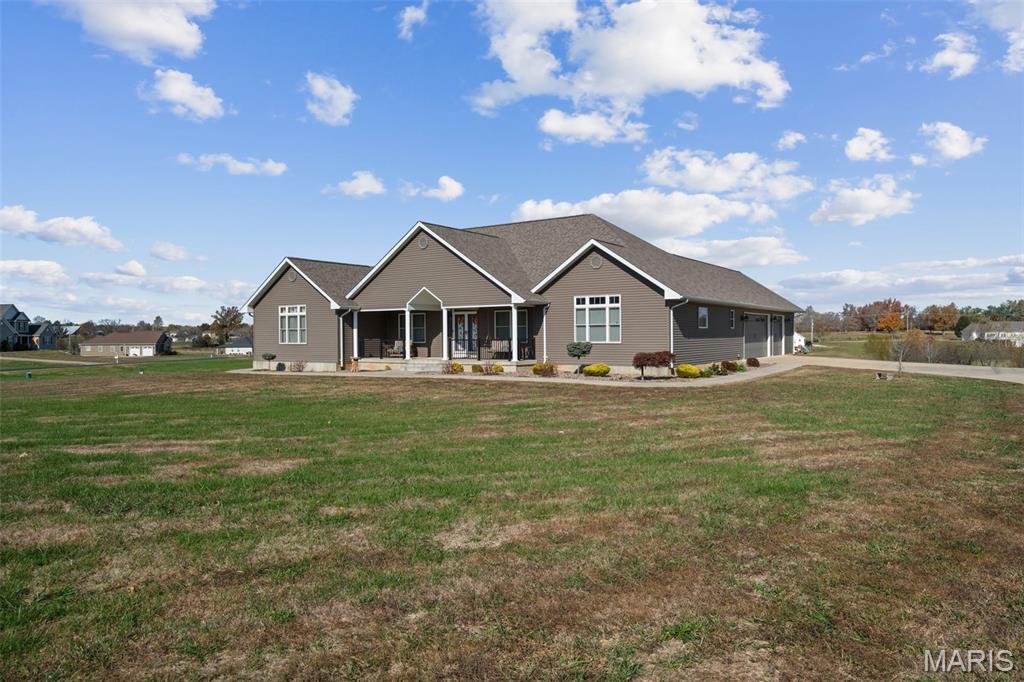 Welcome to this stunning custom-built ranch offering over 4,700 sq ft of total living space, perfectly situated on 2.5 serene acres. Designed for — but not limited to — multigenerational living, this home combines thoughtful functionality with refined craftsmanship at every turn.
The main level features an open floor plan with soaring cathedral ceilings in the living room, elegant cove lighting and a tray ceiling in the dining room, and a gourmet kitchen that’s truly the heart of the home. The kitchen boasts custom cabinetry, quartz countertops, a large island, herringbone tile backsplash, stainless steel appliances, and a convenient coffee bar.
Two primary-style suites provide flexibility for extended family or guests. One suite features a wall of custom built-in bookcases, a spa-like bath with a garden tub, and a separate shower. The main floor also includes a stylish office with built-in shelving and a tray ceiling, plus a laundry room for added convenience.
The walk-out lower level is ideal for in-law quarters or private guest space, offering a full kitchen, laundry room, sitting area, recreation room, bedroom, and full bath — all with the same attention to detail and quality finishes found throughout the home.