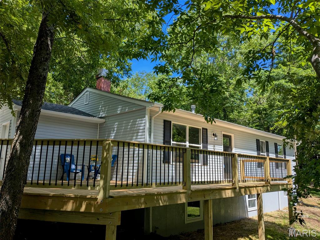 Completely renovated and thoughtfully reimagined, this 4-bedroom, 3-bath home in De Soto offers the rare opportunity to own a property where nearly everything is new. This is a true restoration—not a surface-level update—completed with a high level of care and attention to detail throughout.

Originally a 3 bed / 2 bath, the home has been expanded to a functional 4 bed / 3 bath layout, including a finished lower level with an added bedroom, full bath, and additional living space. An egress window was installed in the basement despite existing walk-up access, adding both safety and flexibility.

The kitchen has been completely redone with granite countertops, stainless steel appliances, and top-end custom cabinetry, along with new flooring throughout the home. The former laundry area has been converted into a full bathroom/laundry combo for improved functionality.

Major improvements include new siding, roof, HVAC, drain tile around the foundation, and connection to public sewer with a private well, providing peace of mind that the important systems have been addressed.

Outside, a substantial 750 sq ft wraparound deck extends from the front to the back of the home, including a covered rear patio entrance, creating a standout outdoor living space.

Situated on a generous lot, this home offers space, quality, and a level of renovation that is hard to find. Completed as if it were being kept long-term, this is a true move-in ready opportunity.