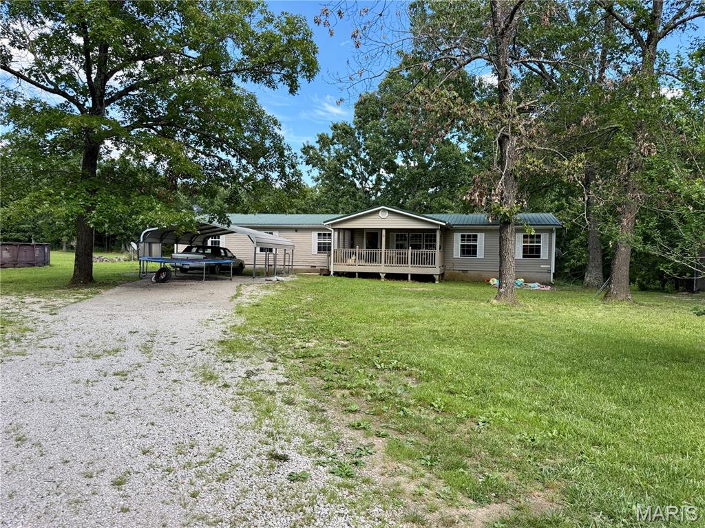 Enjoy the peace and privacy of country living with this spacious 4-bedroom, 2-bath Southern Home manufactured home on nearly 8.8 beautiful acres. Offering 2,280 sq. ft., this 2006 home features vaulted ceilings, 2x6 exterior walls, a concrete slab foundation, and an open-concept layout. The kitchen includes stainless steel appliances and abundant cabinetry, while the split-bedroom floor plan provides privacy. The family room features a cultured stone wood-burning fireplace and a hidden office tucked behind cabinet doors. Outside, relax on the covered porch or deck overlooking a stocked pond filled with catfish, bluegill, and crappie. Cool off in the above-ground pool with a new pump or enjoy the open space for gardening, animals, and recreation. The property also includes a versatile 24' x 48' multi-purpose building with Pella windows, 16-foot ceilings, concrete floors, electric, and plumbing for a kitchen and bath—ideal for a guest home, workshop, or ultimate man cave. A 41' x 18' garage/shop offers additional workspace and built-in shelving for storage. An outdoor wood furnace heats the water, adding efficiency to this unique property.
Whether you're looking for a hobby farm, country retreat, or property with room to grow, this one offers endless possibilities.
