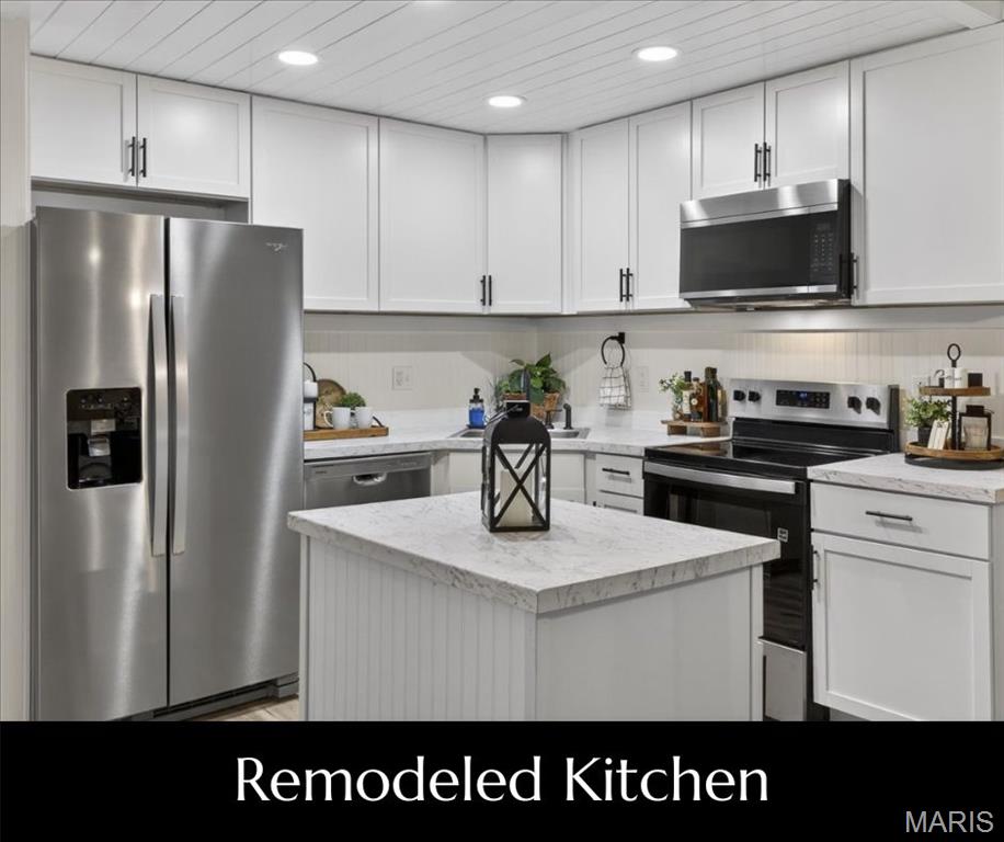 Retreat to 1400 Heritage Landing #203—a thoughtfully renovated 2-bedroom, 2-bathroom WALK-IN condominium offering an open floor plan and modern upgrades throughout. The completely redesigned Kitchen combines function and style with new 36" cabinetry & countertops, stylish hardware, custom backsplash, sink + faucet, and a custom island that anchors the space. The Kitchen opens seamlessly to the Living and Dining areas creating a place to gather or entertain. Both bathrooms have been fully updated with new white vanities, tub/shower and shower surrounds, sleek finishing touches: faucets, light fixtures, mirrors, shelving and hardware. A newly added Laundry Center is discreetly tucked off the Kitchen and adds a layer of everyday convenience without sacrificing style. Fresh wall and ceiling paint throughout enhance the bright, contemporary look, while durable LVP flooring at the main living areas and new carpet at the bedrooms, add comfort.  Additional highlights include custom millwork, baseboards + trim throughout and unique shiplap ceiling at the Kitchen. The one-of-a-kind cubbie area in the Entry Foyer is the perfect combination of style and organization. Assigned carport, additional parking and NO STAIRS make this unit easy to access. New slider gives access to the deck that overlooks the community courtyard. Added bonus - secure closet with storage locker plus community Laundry Center. Heritage Garden is not just a condo complex it's a community. Check out the improvements! Centrally located in St. Charles with easy access to shopping, dining, recreation and major highways, this move-in-ready condo delivers quality craftsmanship, style, and low-maintenance living at a premium location. NOTE: new SELLER CONCESSION: Seller will credit Buyer $2000 towards closing costs OR towards HOA dues at closing.