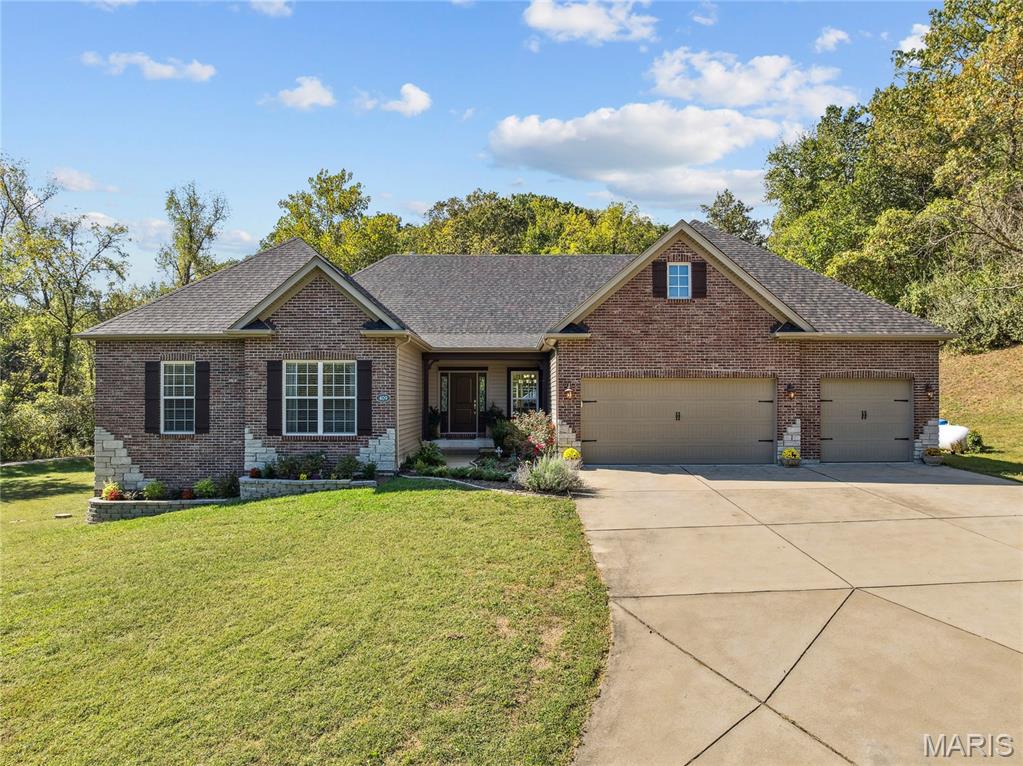 This is your chance to own a one-of-a-kind retreat where the world fades away on exclusive 1.3 acre lot on Griffith Lane.  Move-in ready & impeccably maintained, this stunning Fischer & Frichtel home offers a rare blend of privacy, elegance & endless possibilities. The property includes a privately owned road w/a gated emergency access. Step inside to discover a beautifully appointed gourmet kitchen w/granite countertops, custom cabinetry /pull-outs & an oversized walk-in pantry. The open floor plan flows seamlessly into the inviting hearth room with a cozy fireplace—perfect for relaxing evenings. The main-floor owner’s suite is a private sanctuary, while the wide, upgraded staircase leads to a fully finished w/o basement, providing additional living and entertainment space. No HOA restrictions offering limitless potential—imagine a guesthouse, swimming pool, or even a tennis/pickleball court. All of this just 2 miles from Chesterfield Valley’s premier dining, shopping, and medical.
