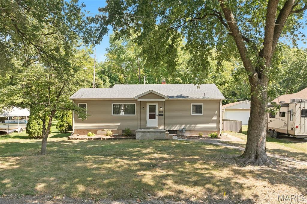 A simple, comfortable 2 bedroom, 1 bathroom home with plenty of space inside and out! Hardwood floors throughout, a basement for extra space and a fenced in yard. The detached 2 car garage gives you plenty of room for parking, storage or even hobbies. This is a great starter home or perfect for anyone looking to downsize without giving up the outdoor space and storage.