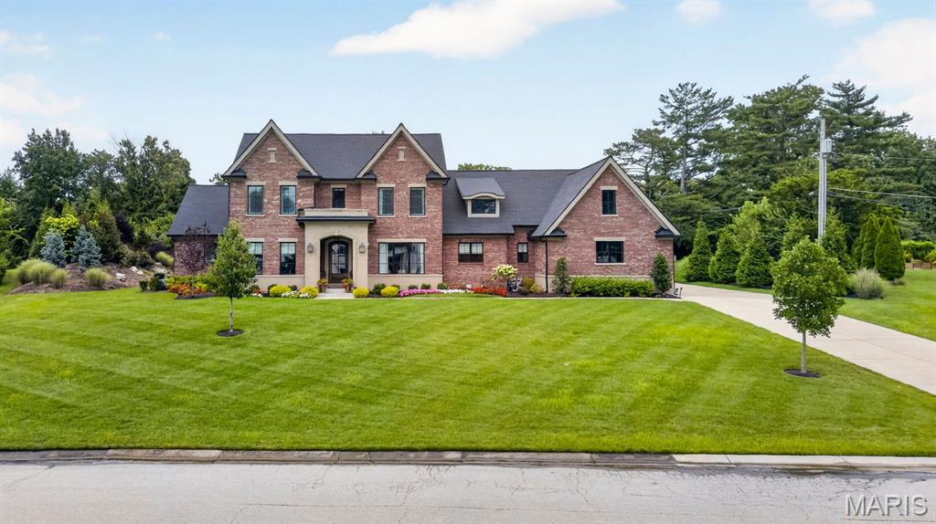 Set on more than an acre of beautifully landscaped grounds in sought-after Frontenac, this extraordinary five-year-old residence pairs timeless design with exceptional livability. Thoughtfully conceived and impeccably finished, the home offers a rare combination of sophistication, comfort, and effortless flow. The main level features a luxurious primary suite, while three additional bedroom suites are privately situated upstairs, creating an ideal arrangement for family and guests. Custom craftsmanship and refined finishes are evident throughout, with every detail carefully considered. Two fireplaces, one anchoring the inviting hearth room and another gracing the impressive great room, bring warmth and character to the home. The finished lower level extends the living space with a spacious family room, exercise room, private office, additional bedroom, and full bath. A covered patio overlooks the beautifully manicured grounds, creating an exceptional setting for entertaining, relaxing, and gathering. A four-car garage adds both convenience and distinction. Elegant without pretense, this lovely Frontenac residence offers a sophisticated yet welcoming setting for gracious living.
Invisible fence, motorized window treatments in Primary and primary bath,Closet Factory Closets