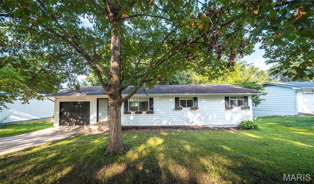 Welcome home to this beautifully updated 3-bedroom, 1.5-bath residence in the heart of Rolla, just minutes from schools, shopping, dining, and everyday conveniences! Step inside to discover luxury vinyl plank flooring throughout and a bright, inviting living room filled with natural light that flows seamlessly into the open kitchen and dining area. The stylish kitchen features sleek stainless steel appliances, a stunning tile backsplash, and plenty of cabinet space for all your culinary needs. The primary bedroom includes a private ensuite half bath, while two additional generous-sized bedrooms, a full guest bath, dedicated laundry room, and hall closet provide comfort and functionality. Step outside to enjoy the covered back patio overlooking a fenced backyard complete with a cozy fire pit area and mature shade trees—perfect for relaxing evenings, entertaining friends, or enjoying family gatherings. Move-in ready and ideally located, this charming home offers the perfect blend of modern updates, comfort, and convenience!