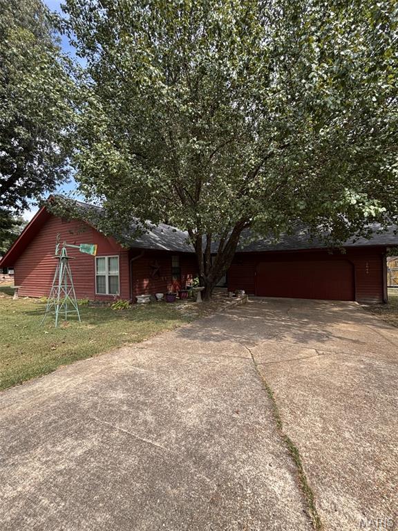 Welcome home to this spacious 3-bedroom, 2-bath home situated on two generous lots in a convenient location close to shopping, dining, and everyday amenities. The home features an oversized kitchen and dining area with plenty of room for gathering and entertaining. Step down into the inviting family room featuring a masonry fireplace with wood stove, creating a warm and comfortable space to relax. Outside, the expansive yard offers plenty of room for kids and pets to play, gardening, outdoor entertaining, or family activities. A two-car garage with overhead storage provides additional space for vehicles and belongings. With its spacious interior, large yard, and convenient location, this home has so much to offer. Schedule your private showing today!