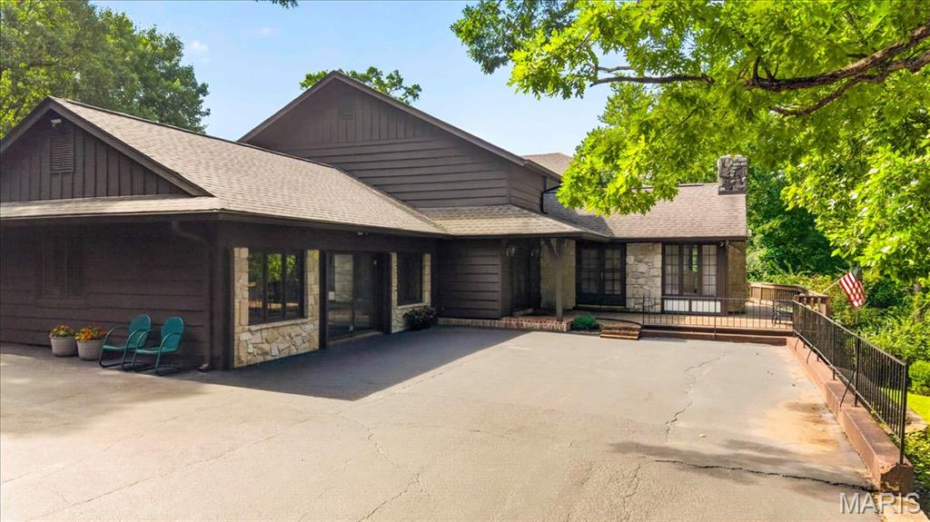 Nestled on nearly 4 picturesque acres and backing directly to Rockwoods Reservation, this one-of-a-kind two-story home offers the perfect blend of privacy, natural beauty, and timeless architectural character. Surrounded by mature trees and peaceful wooded views, you'll enjoy a tranquil retreat with the convenience of nearby amenities. Step inside to a dramatic two-story foyer that opens to a breathtaking great room featuring soaring vaulted ceilings, exposed wood beams, a floor-to-ceiling brick fireplace, a walk-behind bar, and walls of windows that fill the home with natural light. Rich wood accents throughout create warmth and timeless charm. The spacious kitchen is designed for gathering with abundant cabinetry, generous counter space, a center island, a planning desk, double ovens, a stunning brick fireplace that adds warmth and character, and an adjoining breakfast area. A formal dining room provides the perfect setting for larger gatherings. Upstairs, the expansive primary suite serves as a private retreat with hardwood flooring, a large walk-in closet, and an ensuite bath featuring dual vanities, a soaking tub, and a separate shower. 4 Generously sized secondary bedrooms and 2 full baths offer comfortable accommodations for family and guests. One of the home's most unique features is the expansive main-level recreation room, complete with rustic wood ceilings, exposed beams, a striking stone fireplace, and a built-in hot tub! Creating the perfect space to entertain, unwind, or enjoy year-round relaxation. Step outside to a multi-level deck with a covered gazebo overlooking the peaceful, wooded backyard. Whether you're enjoying your morning coffee, hosting summer gatherings, or simply taking in the surrounding nature, this outdoor space is designed to be enjoyed. A detached outbuilding offers additional space for a workshop, hobbies, or extra storage. If you've been searching for a home that offers exceptional architectural character, incredible indoor and outdoor living spaces, and the privacy of acreage, this is one you won't want to miss!