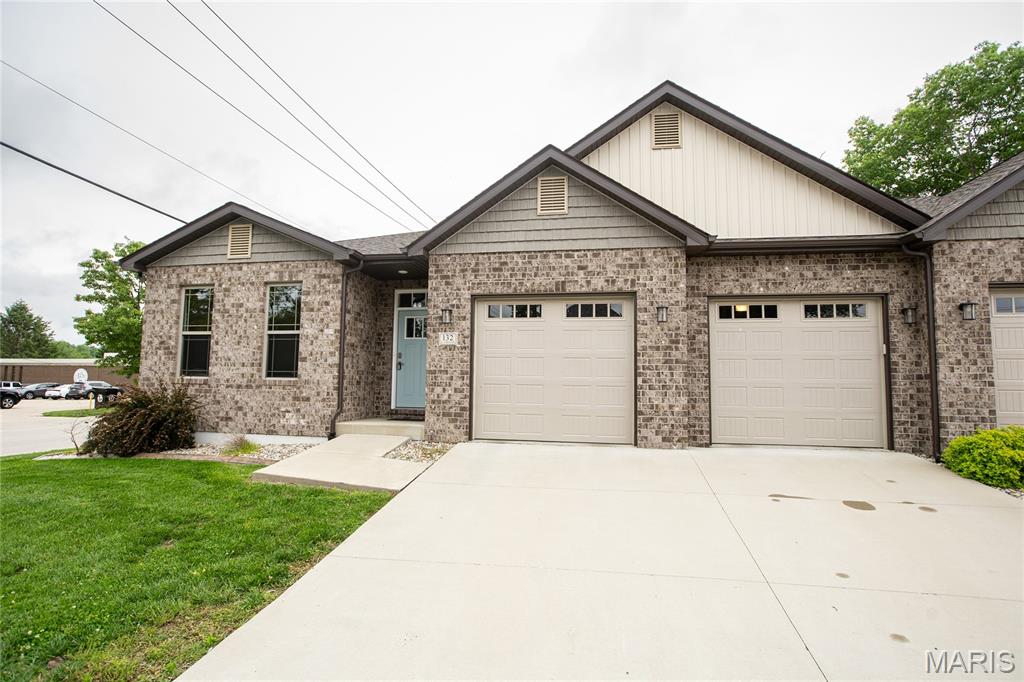 Impressive 4 BR 3 BA Full-Brick Villa in the Heart of Columbia.  Beautiful corner lot directly across from the library and Metter Park. Walk to Historic Main Street, shops, restaurants, and local businesses.  This open, light-filled home features three bedrooms and two full baths on the main level, including a primary suite with dual vanity. Enjoy the expansive great room, bright breakfast area, and gourmet kitchen with quartz countertops, custom tile backsplash, stainless appliances, walk-in pantry.  Ceiling fans, main-level laundry rm, covered back patio, vinyl luxury plank flooring, and professional landscaping.  Lower level includes a large fourth bedroom with full bath and custom closet, spacious finished rec room, add’l unfinished space ideal for storage, gym, or workshop, plus large storage closets. Oversized 2-car garage featuring dual EV chargers.