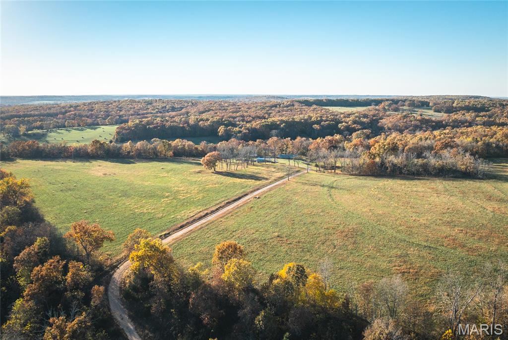 Located in Texas County, Missouri, this 200 m/l acre property offers the perfect blend of productive farmland, comfortable living, and recreational opportunity. With a great mix of open pasture and wooded acreage, this farm is ideal for raising cattle, hay production, hunting, or simply enjoying the beauty of rural Missouri. The property features an earth home with 3 bedrooms and 2 full bathrooms, offering energy efficiency and year-round comfort. A greenhouse and fenced garden area provide the perfect setup for growing your own produce, while an equipment barn offers storage for tools, tractors, and farm machinery. The land itself is well-suited for hay production or cattle farm, featuring gently rolling pastures and a pond on the property. The balance of wooded land makes for excellent hunting opportunities as Texas County is known for its abundant deer and turkey population, providing outstanding recreation right out your back door. Located approximately 1.5 miles off Highway 38 on a gravel road, the property offers great privacy while remaining conveniently close to main road access.