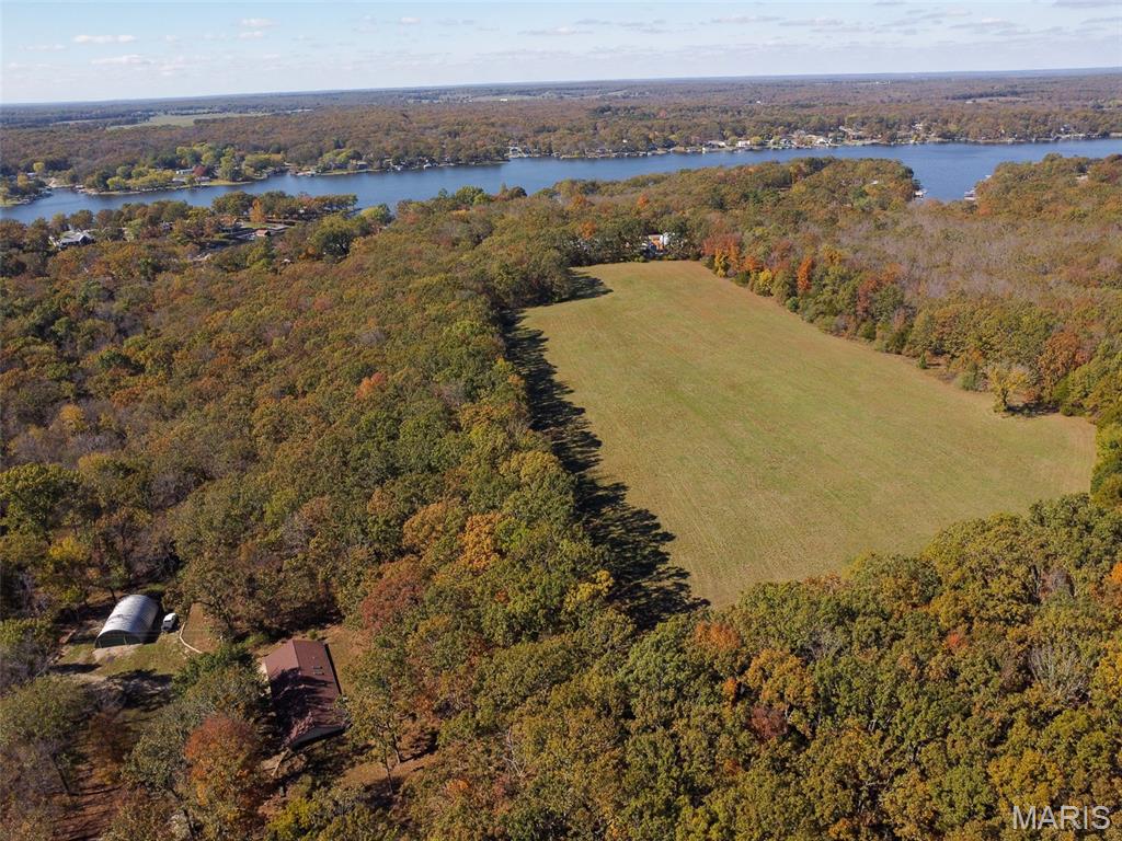 If you’ve been dreaming of space, privacy, and country living—this 56-acre property has it all! A beautiful mix of open pasture, mature timber, and a peaceful creek make this the perfect place to call home or start your next adventure. Tucked away at the end of a private drive, yet just minutes from town, you’ll love the balance of quiet country life and everyday convenience. The energy-efficient earth home offers an open, inviting layout with vaulted ceilings, skylights that brighten every room, and large casement windows showcasing the scenic Ozark views. It features 2 bedrooms with potential for a 3rd, an eat-in kitchen, and an attached garage. Outside, there’s plenty of space for your hobbies and livestock with an extra 1-car garage and a Quonset Hut—perfect for storing equipment, tools, or UTVs. This property is truly move-in ready and waiting for someone to make it their own. Don’t miss your chance to enjoy peaceful country living—schedule your showing today!