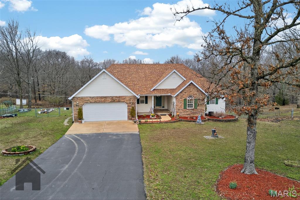Discover this nicely landscaped Ranch-style house located just minutes from the front gate of Fort Leonard Woodl This house offers four bedrooms (including a non-conforming basement bedroom) and three bathrooms. The lovely kitchen features granite countertops, three sinks (one with reverse osmosis), tile flooring and backsplash, recessed lighting, cherry-finish cabinetry, and a closet pantry. Stainless steel appliances include a French-door refrigerator, and the kitchen also offers two garbage disposals and a breakfast bar with seating for two to three.

The dining room includes a bay window, chandelier, and access to the covered deck. The carpeted living room has a vaulted ceiling and lots of natural lighting. The home received a new roof in 2022 and has leaf-guard gutter covers. Additional features include a whole-home water filtration system and a premium water softener.

Outside, the chainlink fenced backyard offers a covered deck and a back patio and a covered concrete front porch. The tiled entry foyer includes a closet. A security system is installed, and the basement provides a large storage area. An extra basement refrigerator and washer and dryer may also be included.