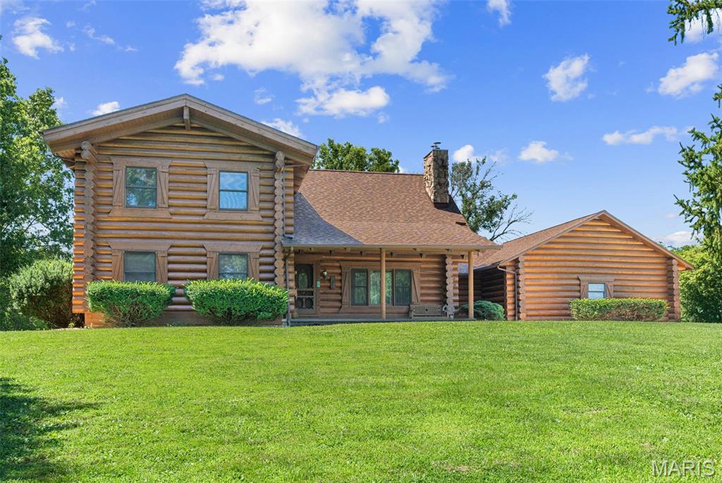 5.29 UNRESTRICTED ACRES JUST OUTSIDE OF TOWN! Opportunities like this don't come around often! Experience the perfect blend of rustic luxury, privacy, and convenience with this stunning custom *Rocky Mountain Log Homes of Montana* 1.5-story log home, located just 5 minutes from downtown Washington, local wineries, shopping, dining, and everyday amenities. Situated on level 5.29 acres with a small pond, mature trees, open pasture, and exceptional privacy, this one-of-a-kind property offers the country lifestyle you've been dreaming of without sacrificing convenience.

Crafted with impressive 12-inch diameter logs and 2x6 construction, this remarkable home welcomes you with a covered front porch leading into an impressive two-story entry and expansive vaulted great room featuring a cozy wood-burning fireplace as the centerpiece. The open-concept design flows effortlessly into the beautifully updated chef's kitchen complete with Pergo flooring, quartz countertops, tile backsplash, a center island, abundant cabinetry and workspace, stainless appliances including barely used double ovens including a convection oven, upgraded gas cooktop, and a statement range hood sure to impress any home chef. The adjoining breakfast area creates the perfect gathering space overlooking the large deck with views of your peaceful and private surroundings.  The main floor also offers a convenient laundry room and half bath just off the attached garage. The spacious primary bedroom is a true retreat featuring dual walk-in closets and French doors leading to an incredible 20x30 deck overlooking the peaceful countryside. Updated  bathroom showcases an oversized custom tiled walk-in shower with dual benches and double vanity. A second main-floor bedroom also features a generous walk-in closet or use as a flex space, craft room or office.

Upstairs you'll find three additional oversized bedrooms with beautiful knotty pine flooring and a spacious full bath with a tub/shower combination.

The walkout lower level offers endless possibilities with a French door walkout to the patio, rough-in plumbing for future finishes, 2nd separate flu to add a fireplace downstairs, a full concrete storm shelter beneath the porch, plus an additional secure safe room ideal for valuables or personal safety.

Outside, the custom-built barn is ready for horses, livestock, hobbies, or equipment storage and features a tack room, wash bay drain, existing stall with room to expand, oversized garage door for equipment or trailer access, an upstairs storage loft, and an attached lean-to.

Maintenance care that you will love has been done for you: High efficiency HVAC (Furnace 4 years, AC 5 years)  and cleaned/serviced 2026,  Architectural roof installed 2023,
Deck refreshed 2026, House exterior sealed 2026.

Whether you're looking for a hobby farm, equestrian property, workshop space, or simply room to spread out and enjoy country living, this unrestricted property offers endless opportunities without having to move to the Dutton Farm of Yellowstone! 
Don't wait to schedule your private showing—properties like this rarely become available!
Seller is selling property as-is.