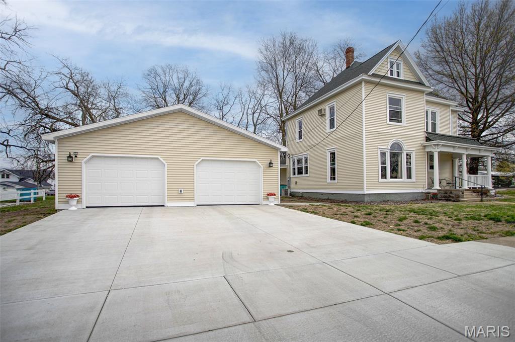 Historic charm meets modern updates in the heart of Pittsfield, Pike County, Illinois! Originally built in 1890, this beautifully maintained home showcases timeless character with original woodwork, pocket doors, built-ins, a stunning stained glass windows, and 12-foot ceilings throughout. The original fireplace, now featuring a gas insert, adds warmth and charm to the main living space. The home has been thoughtfully updated with a refreshed kitchen and bathrooms while preserving its classic appeal. Step outside to enjoy covered porches—perfect for relaxing with your morning coffee or unwinding in the evening. Situated on an extra-large lot, this property offers plenty of space for a yard, garden, or outdoor entertaining. The impressive 30x36 oversized 4-car detached garage (built in 2024) provides ample room for vehicles, storage, and hobbies, and is complemented by a brand-new concrete driveway and sidewalk surrounding the garage. Upstairs, you’ll find four spacious bedrooms, a full bath, convenient laundry, and additional storage. An unfinished attic offers even more potential for storage or future expansion. This is a rare opportunity to own a historic home with modern comforts and room to grow—don’t miss it!