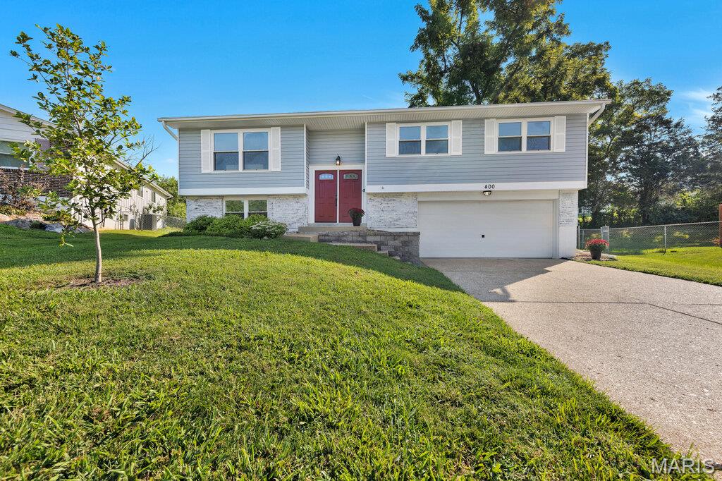 The summer is officially over and school is back in session.  Now let's focus on getting your home settled!  ** OPEN HOUSE SUNDAY, SEPTEMBER 13TH 1P-3P ** Welcome to 400 Coventry Lane, a spacious 3 bedroom, 2 bath split-foyer home offering plenty of room to spread out, fantastic outdoor living, and highly regarded Parkway Schools without the million dollar price tag!

Beautiful hardwood floors welcome you into the foyer and continue through the living and dining rooms. The living room features a large, sunny picture window that brings the outdoors in without bringing along the humidity and bugs. The adjoining dining room features a chandelier and slider to the impressive 41' wood deck, creating an easy flow from indoor meals to outdoor gatherings.

The bright kitchen offers plenty of room for prep work and serving with new butcher block counters, stainless steel appliances, a coffee bar, serving buffet, and generous counter space. Whether you're cooking for one or feeding a crowd, this kitchen is ready to work with you.

All 3 bedrooms feature comfortable carpeting, while fresh paint throughout gives the home a clean, refreshed feel. The primary bedroom has its own slider to the deck, making it easy to step outside with your morning coffee or unwind at the end of the day.

And what a deck it is!  Overlooking the large, flat, chain-link fenced backyard, this expansive outdoor living space is perfect for entertaining, relaxing, overseeing backyard play, or simply enjoying the extra breathing room. The large yard offers plenty of space for pets, games, gardening, or whatever outdoor fun fits your lifestyle.

Downstairs, the large carpeted family room gives everyone another place to spread out and includes a slider to the covered patio for even more indoor and outdoor living options. The tuck under 2-car garage enters through a convenient foyer/mudroom area, giving shoes, bags, and everyday mess a place to land before entering the rest of the home.

Important updates include a newer 100-amp electrical panel, gas water heater (2023), and AC & coil (2023). Add in the oversized yard, multiple outdoor living spaces, fresh interior, pride of ownership, and sought-after Parkway Schools, and 400 Coventry Lane delivers the space and flexibility you've been searching for at an attainable price.  

Don't Sleep on Your Dream Home, Sleep in It!