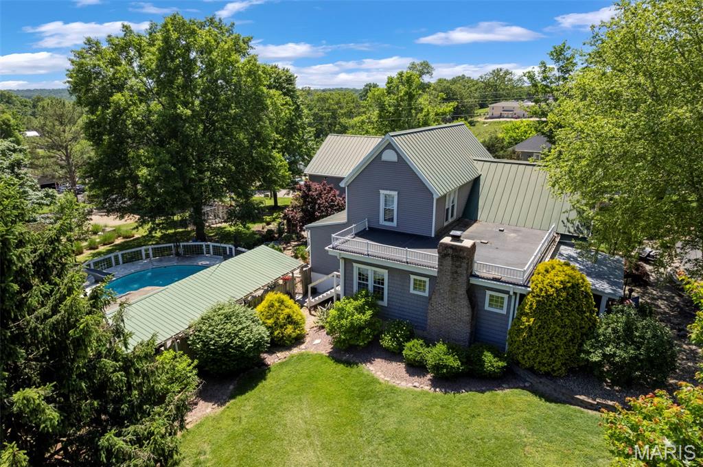Step into timeless charm with this beautifully restored 1888 historic home offering the perfect blend of character and modern convenience. Boasting 2,286 sq. ft. on the main level plus a finished basement with an additional 576 sq. ft. of living space, this stunning 1.5-story home features 3 bedrooms and 1full and 2 half baths, including one bedroom on the main level and two bedrooms upstairs with an additional versatile room perfect for an office, nursery, or walk-in closet. Inside, you’ll fall in love with the original hardwood flooring, exquisite historic millwork, crown molding, built-in bookcases, and a cozy gas fireplace anchoring the living room. The remodeled kitchen is designed for both function and style with granite countertops, a pantry, and convenient main-level laundry. Bathroom has shower and separate tub.


Outdoor living is just as impressive with a welcoming screened-in front porch and an entertainer’s dream backyard featuring a stone fireplace patio, above-ground pool with wraparound deck, and a covered gathering area perfect for hosting family and friends. The property also includes a heated and cooled 30x40 detached garage complete with three overhead doors and a half bath. Above the garage, you’ll find approximately 1,200 sq. ft. of additional living space ideal for guests, a mother-in-law suite, or private retreat.


Situated on .77 +/- acres, this one-of-a-kind property also offers a chicken coop, RV carport, and additional outbuilding, providing endless possibilities for storage, hobbies, and ample room for the kids to play. A rare opportunity to own a truly special historic property with modern updates and exceptional amenities!