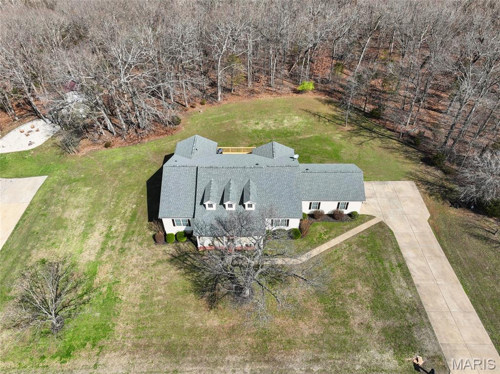 Back on market, no fault of seller. You have another chance to view this Peaceful Property Retreat! 
Set on four scenic acres, this bright and welcoming walk-out ranch offers peaceful surroundings, spacious living, and an attached two-car garage. Vaulted living areas, large windows, and an open entry create a warm, light-filled atmosphere throughout the home. The kitchen features custom cabinetry, tile flooring, a basketweave tile backsplash, window-seat storage bench, and walk-in pantry. A large breakfast and dining area just off the kitchen opens through double glass doors to a full deck overlooking tranquil tree-lined acreage. A screened porch provides another inviting outdoor living space. The primary suite includes updated double vessel sinks, a full bath with separate shower, and walk-in closet. Two additional bedrooms offer generous closet and storage space and share another full bath, with main-level laundry nearby. The finished walk-out lower level offers flexible living space with oak-lined walls, an electronic fireplace, tile shower, bonus room for a fourth bedroom or office, and space for storage or future kitchenette. Updates include roof and premium HVAC within five years, plus new water heater, water softener, and septic aerator in 2025.  2C Garage (oversize) offers plenty of additional storage space or for those large oversized vehicles.