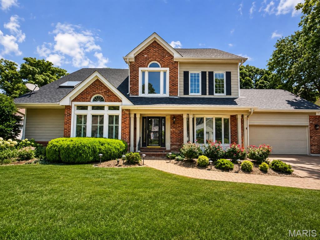 A tremendous value in the highly sought-after The Forest subdivision in Chesterfield, this 1.5-story brick and Hardie-sided home offers more than 4,000 square feet of living space with an exceptional blend of thoughtful updates, and surrounded by a serene and private wooded setting. From the moment you arrive, the paver driveway, attractive exterior, and mature landscaping create stunning curb appeal. Inside, the home offers a spacious and functional floor plan designed for both everyday living and entertaining. The main-floor primary suite serves as a private retreat featuring direct access to the expansive rear deck and a beautifully updated primary bath. The heart of the home features a large great room with soaring ceilings, a wet bar, and fireplace, creating an inviting gathering space filled with natural light. The main level also includes a generous formal dining room with bay window, separate living room, and an expansive eat-in kitchen with granite countertops, stainless steel appliances, and abundant cabinetry. Just off the kitchen, a charming sunroom offers the perfect place to relax while overlooking the beautiful wooded backyard. Step outside to enjoy one of the home’s standout features — a large deck spanning the width of the home, complete with a covered awning and ceiling fans, creating an exceptional outdoor entertaining space with peaceful privacy. The second floor offers three additional spacious bedrooms, two full bathrooms, and a large loft area, providing flexibility for family, guests, or home office area. The finished walk-out lower level expands the living space even further with a nicely appointed recreation area, small kitchenette, full bath, and abundant storage space. Don't miss the level fenced in area off the walk out lower level perfect for a play space or English Garden. Additional features include attached 2-car garage, upgraded windows, extensive storage throughout, a new retaining wall and so much privacy and natural beauty.